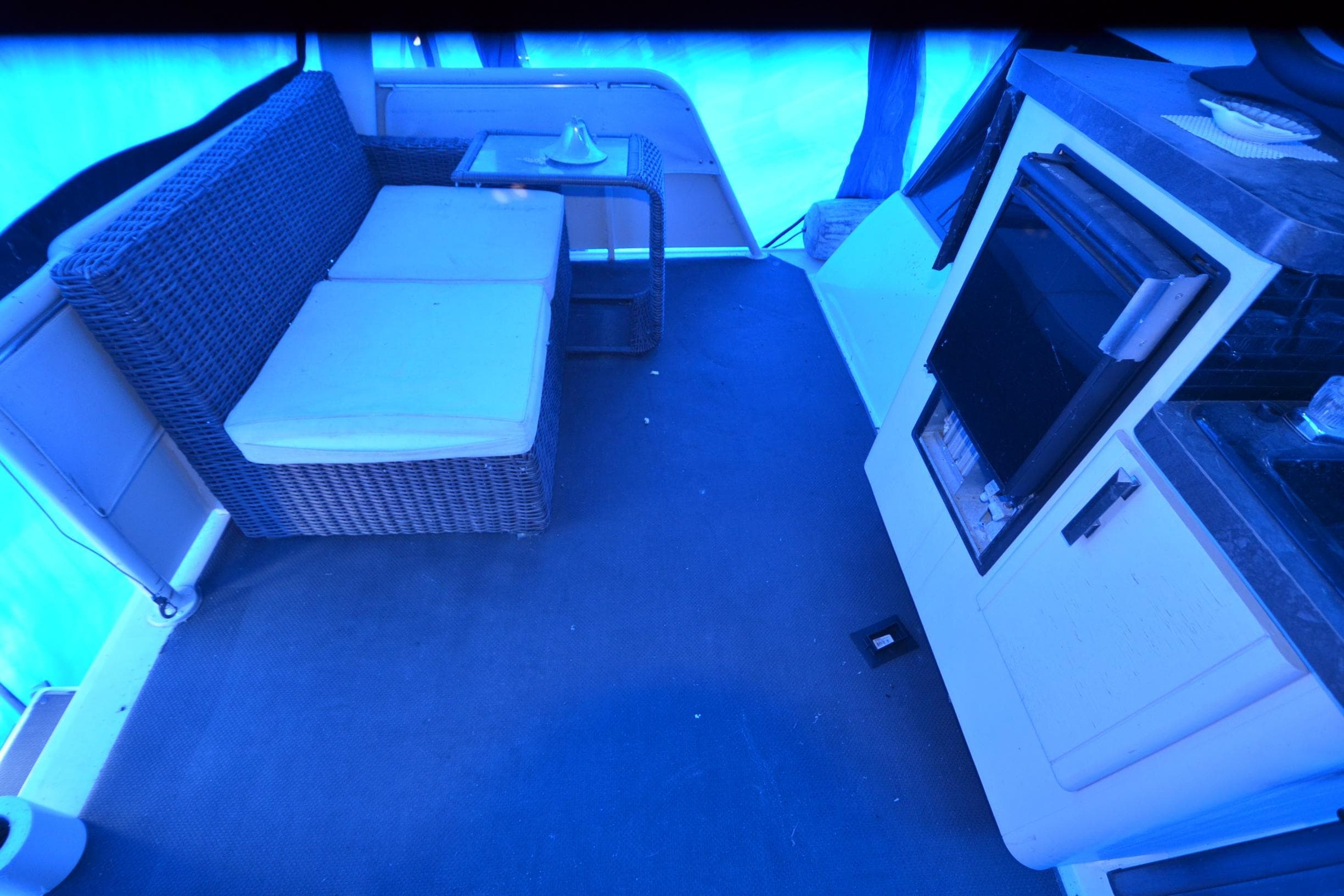 Interior of 1989 Silverton 46 Aft Cabin with wicker seating and kitchenette.