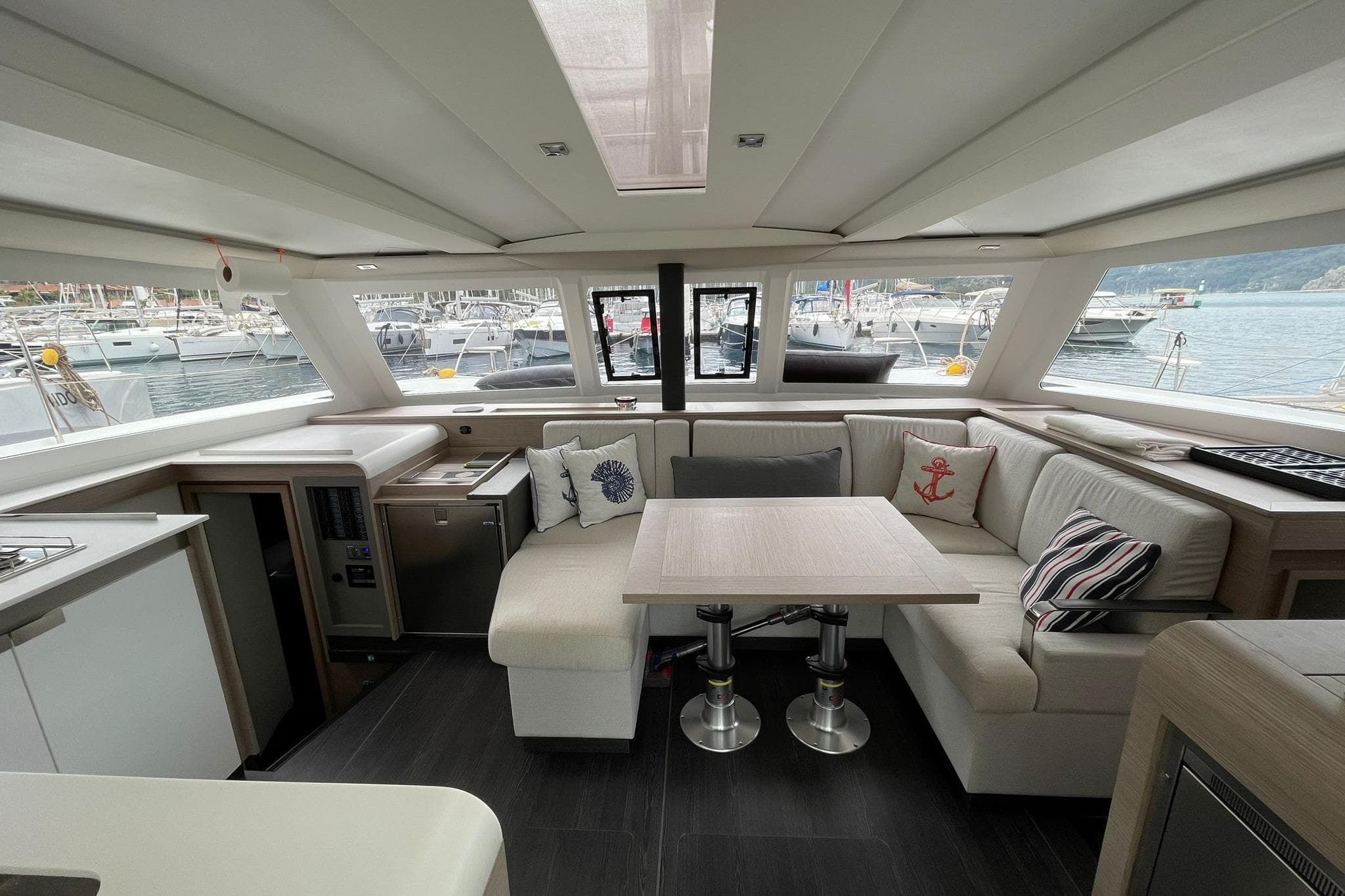 Luxurious interior of 2022 Fountaine Pajot Isla 40 catamaran with elegant seating and dining area.