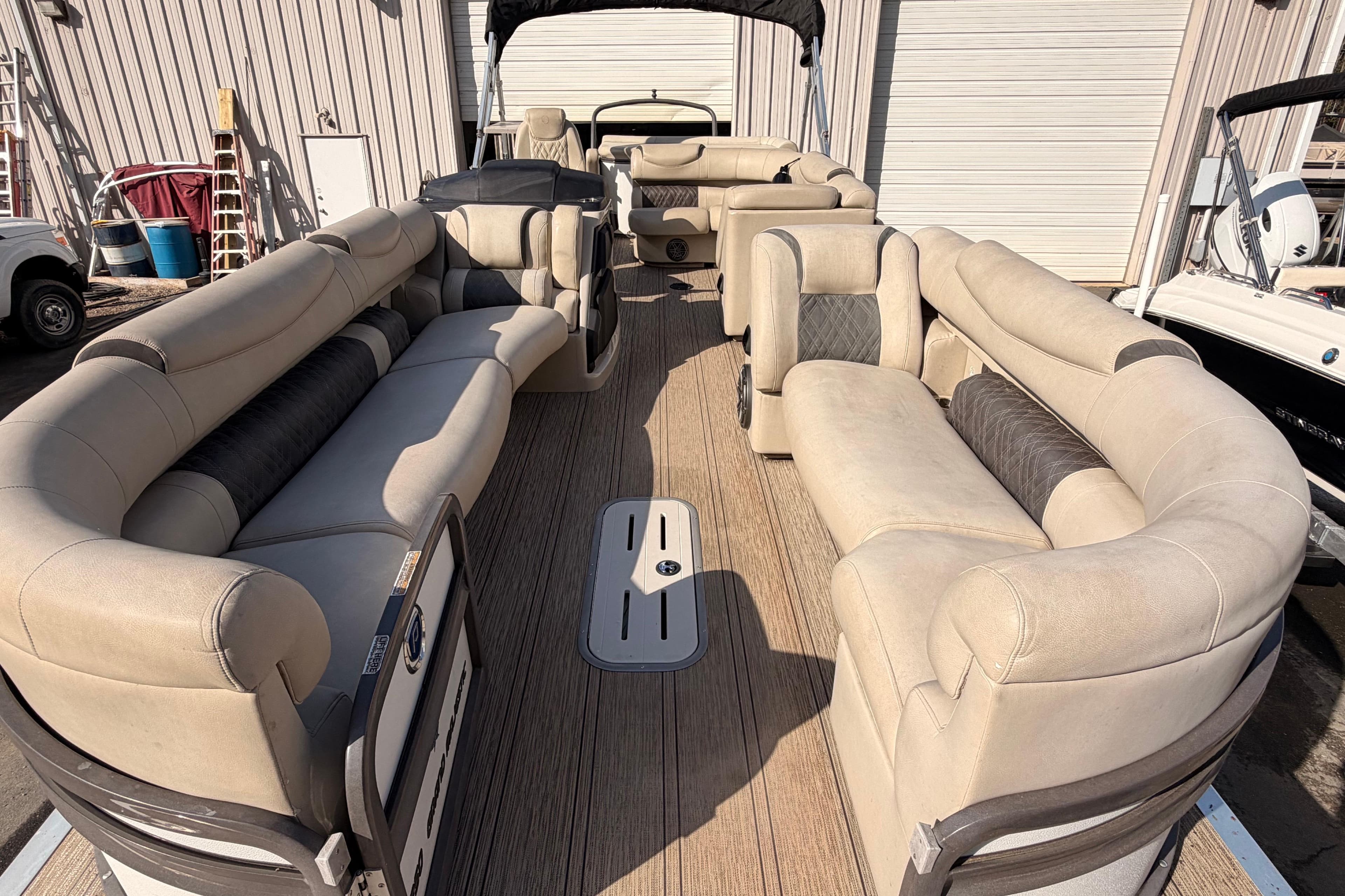Luxurious 2021 Premier 250 Grand Majestic pontoon boat with spacious seating and elegant design.