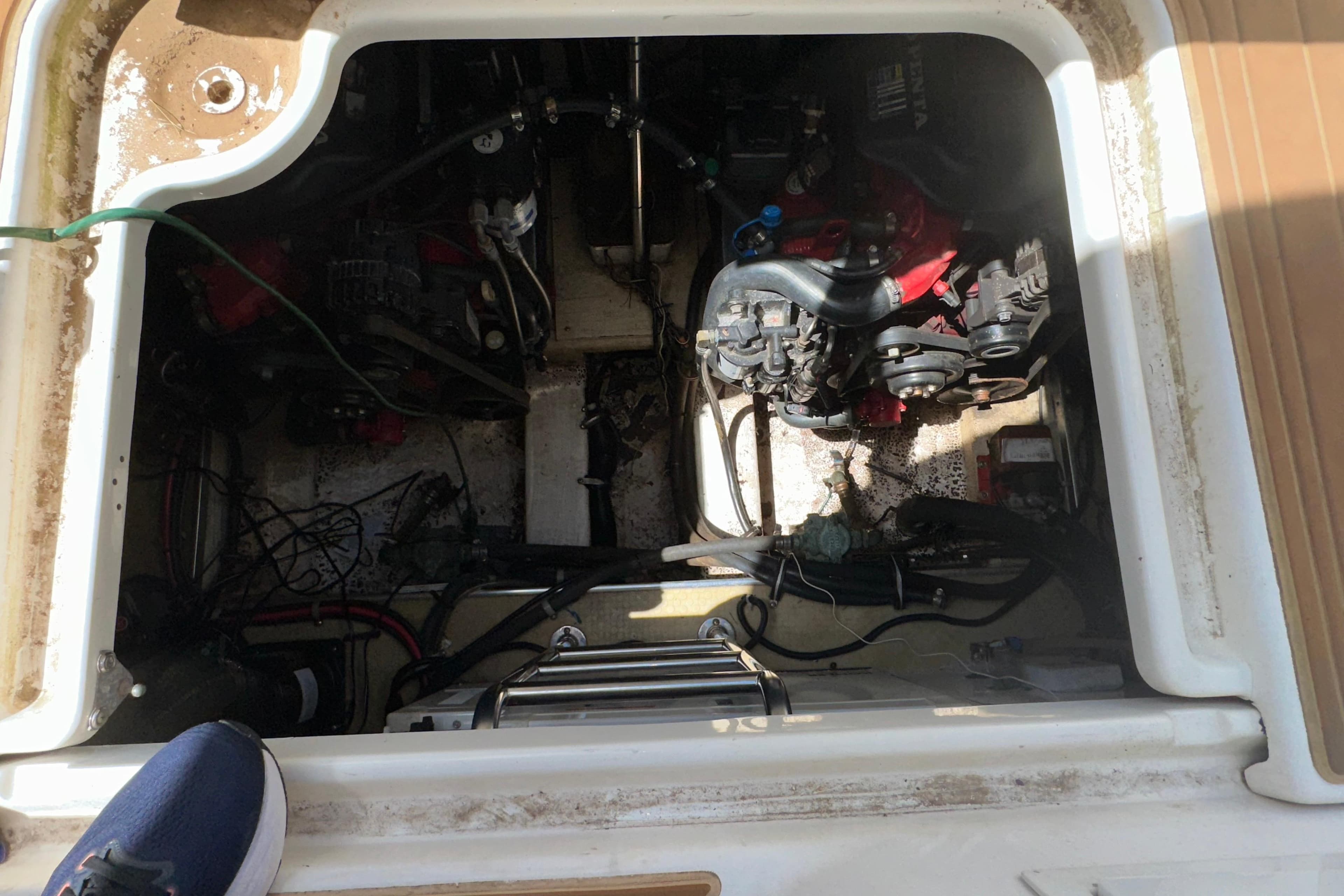 Engine compartment of a 2006 Larson Cabrio 350 boat, showing mechanical components and wiring.