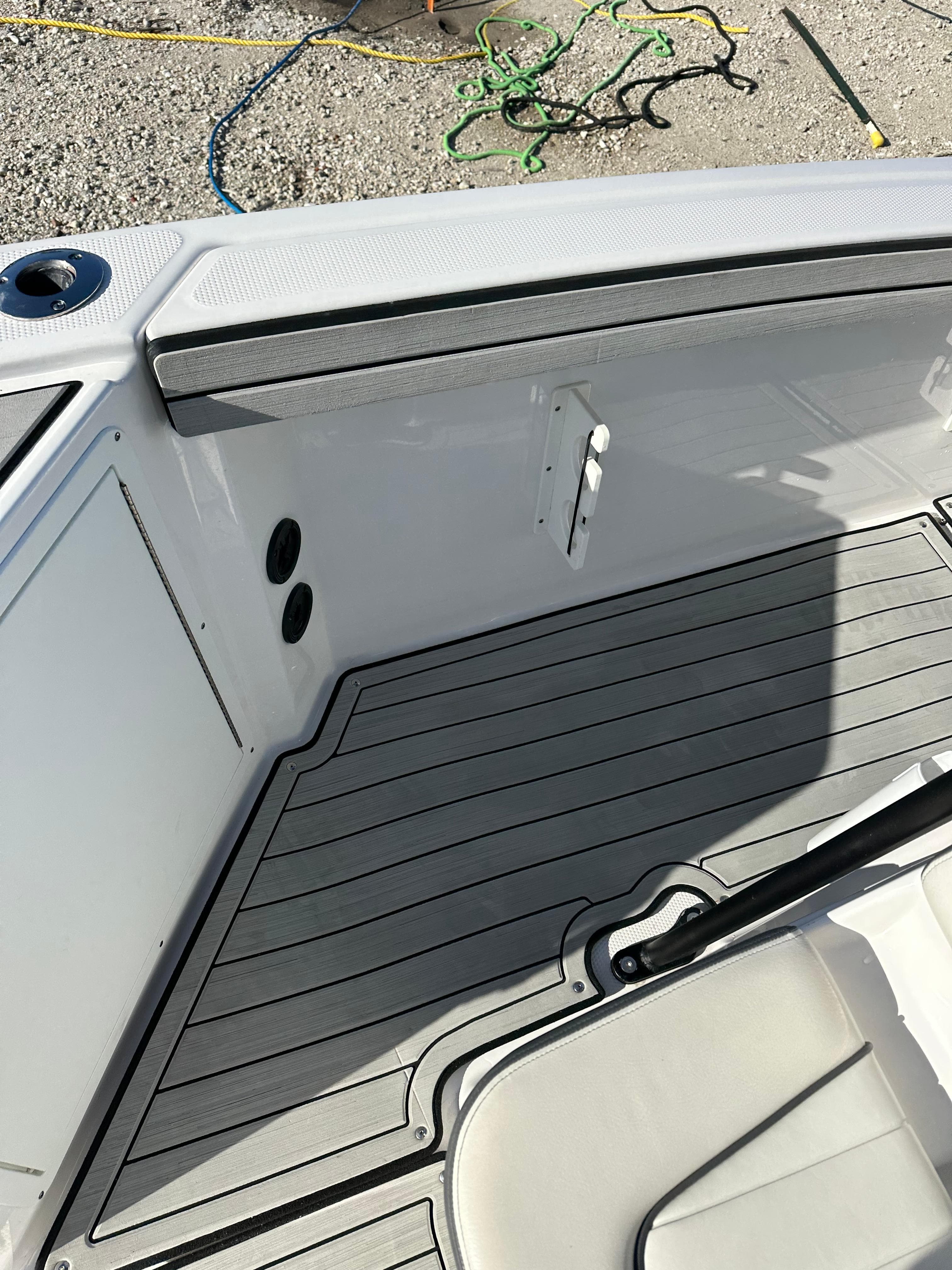 2021 Yamaha Boats 210 FSH Sport interior, featuring sleek deck design and modern fittings.