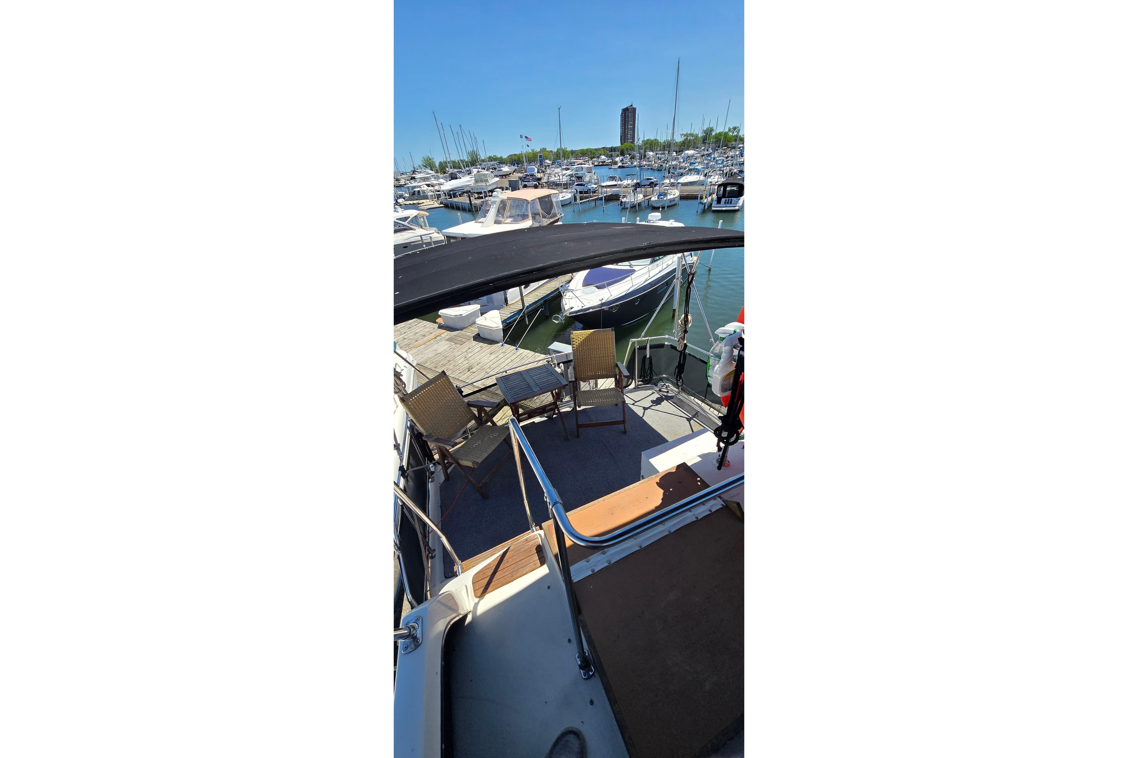 1985 Carver 3207 Aft Cabin Motor Yacht docked at marina with chairs on deck.