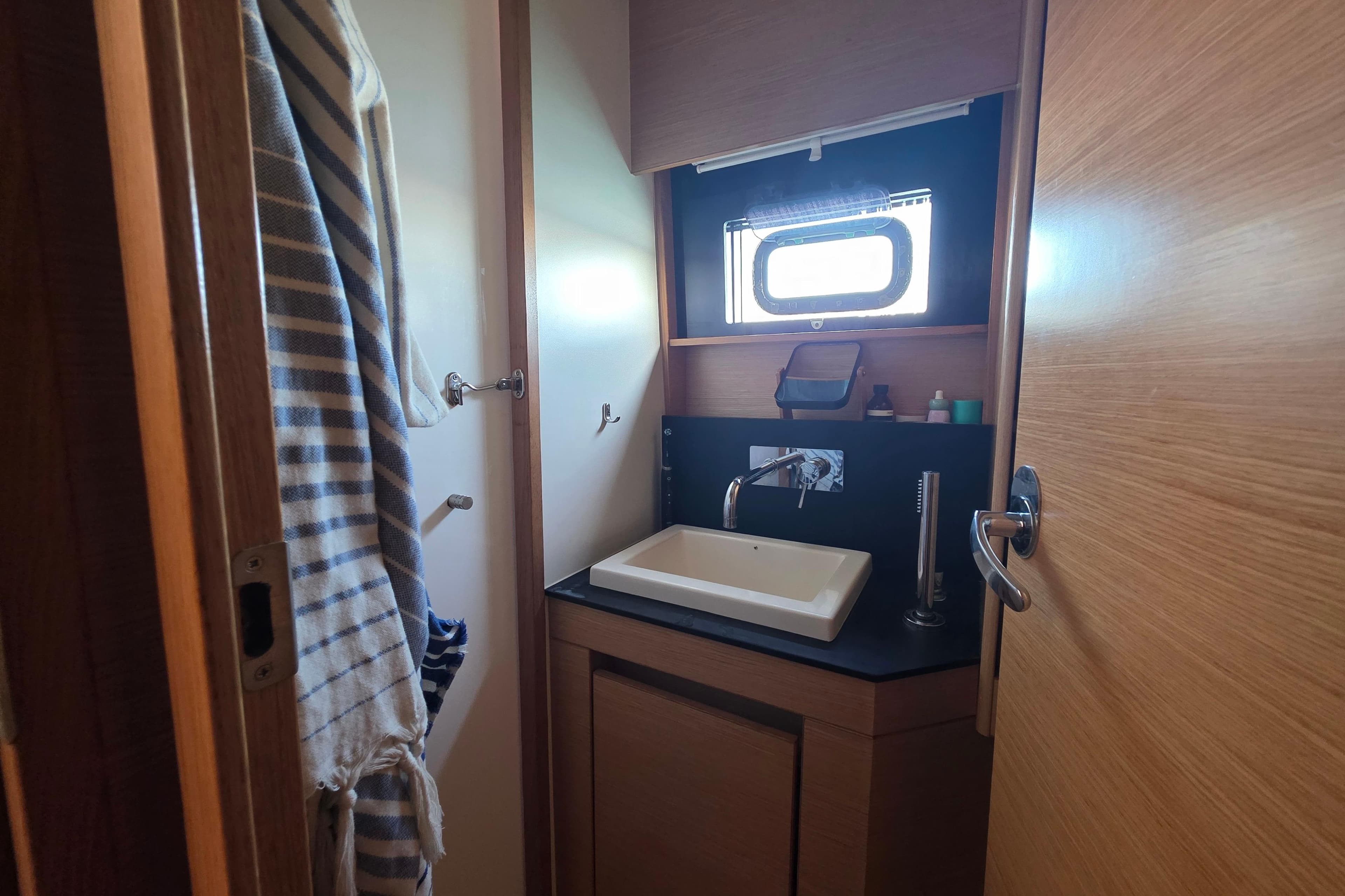 Bathroom interior of 2019 Nautitech 46 Open yacht, featuring sink and window.