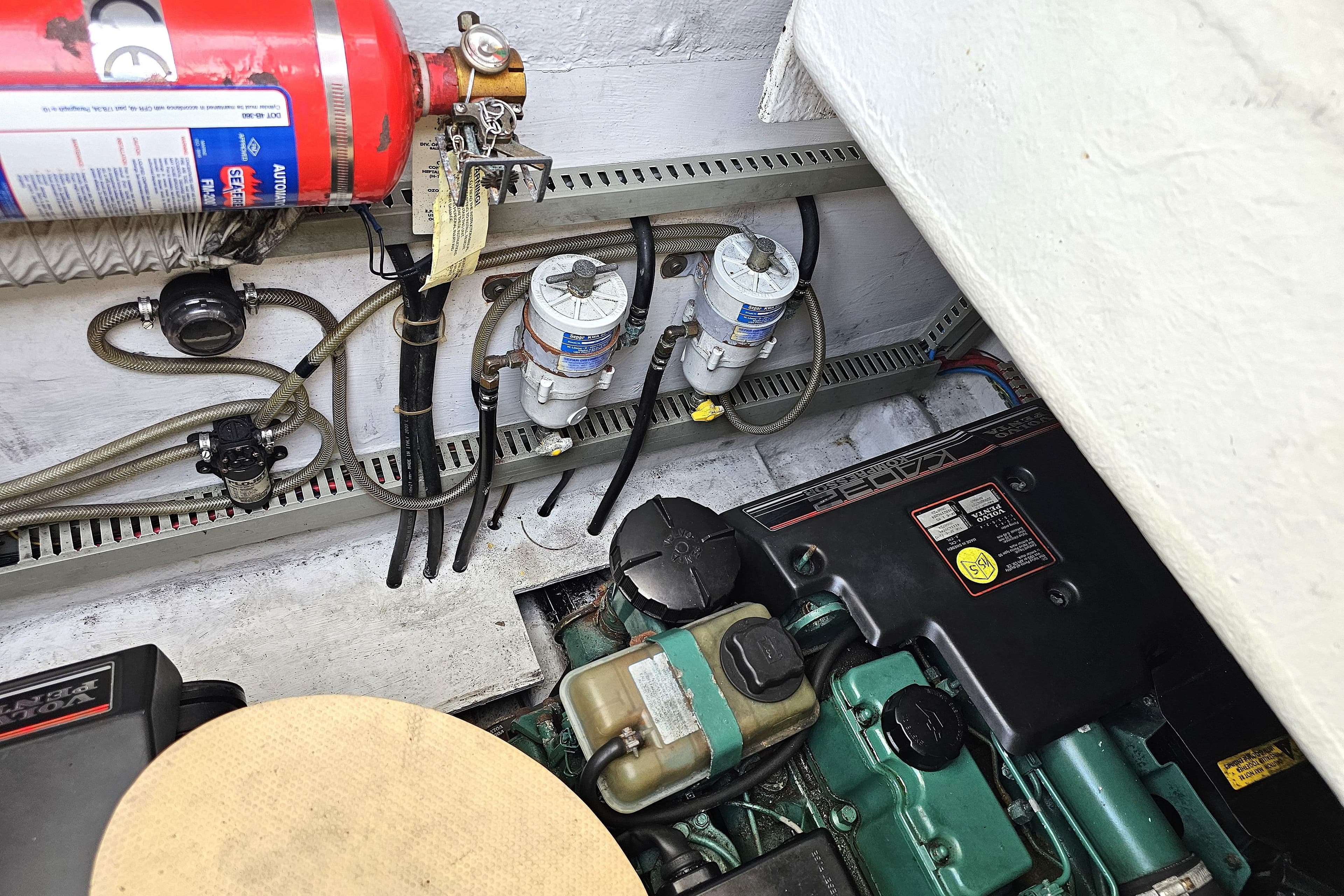 Engine compartment of 2000 Fairline Targa 30 with fire extinguisher and fuel filters visible.