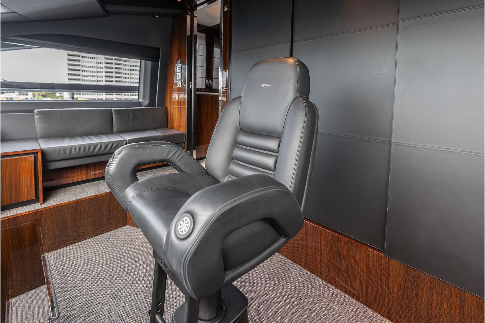 Luxurious interior of 2024 Riva 130' Bellissima yacht with sleek black seating.