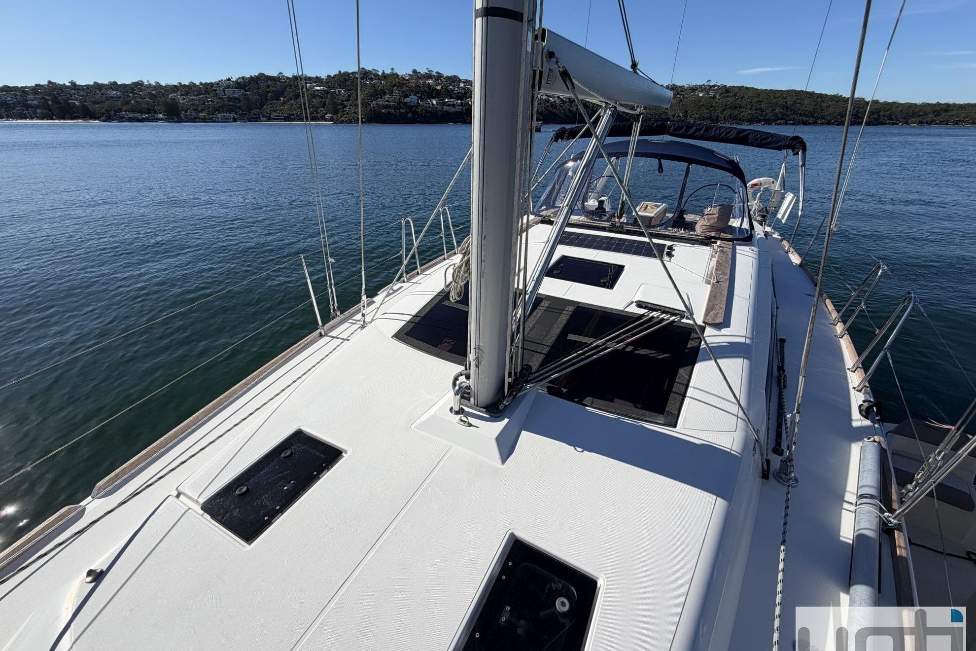 2018 Dufour 410 sailboat on calm water, showcasing deck and rigging.