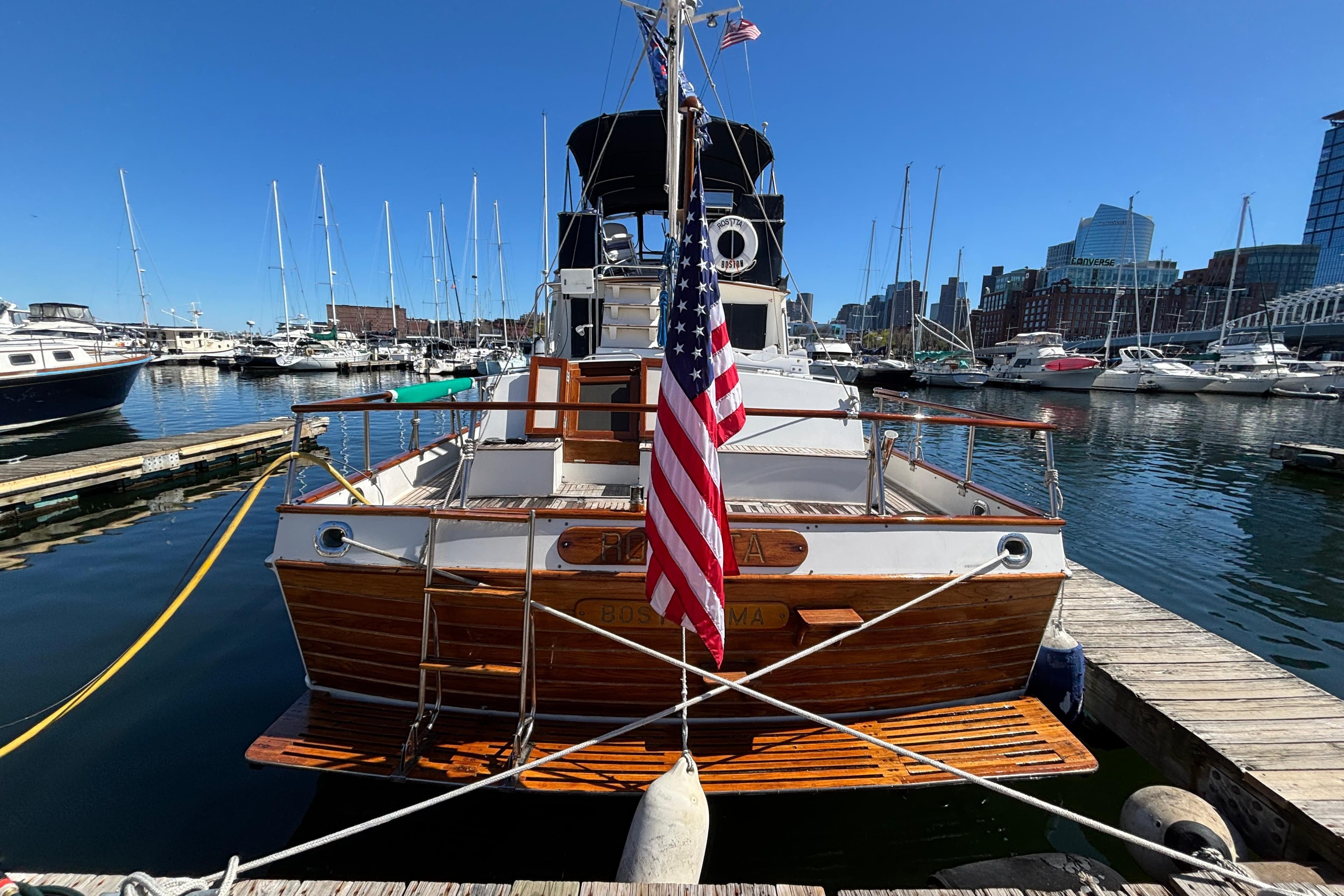 1987 Grand Banks 42 Classic yacht docked in a marina, featuring an American flag.