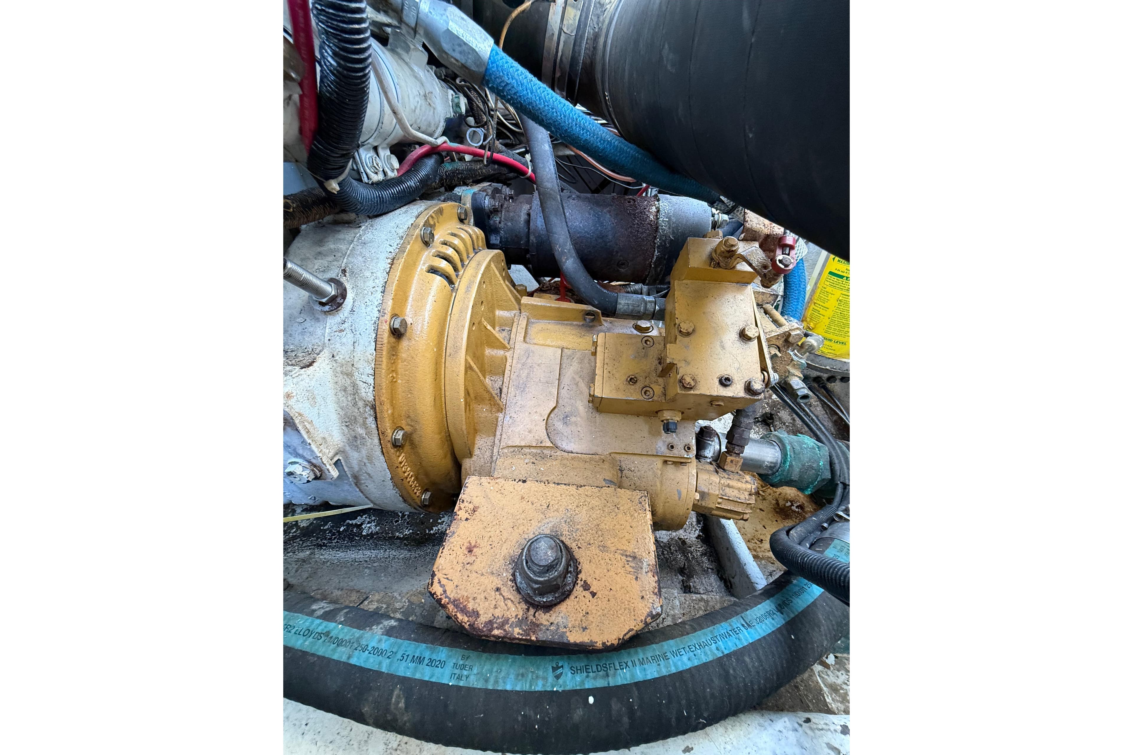 Engine compartment of a 1988 Stuart Angler 32 boat, showcasing mechanical components and hoses.