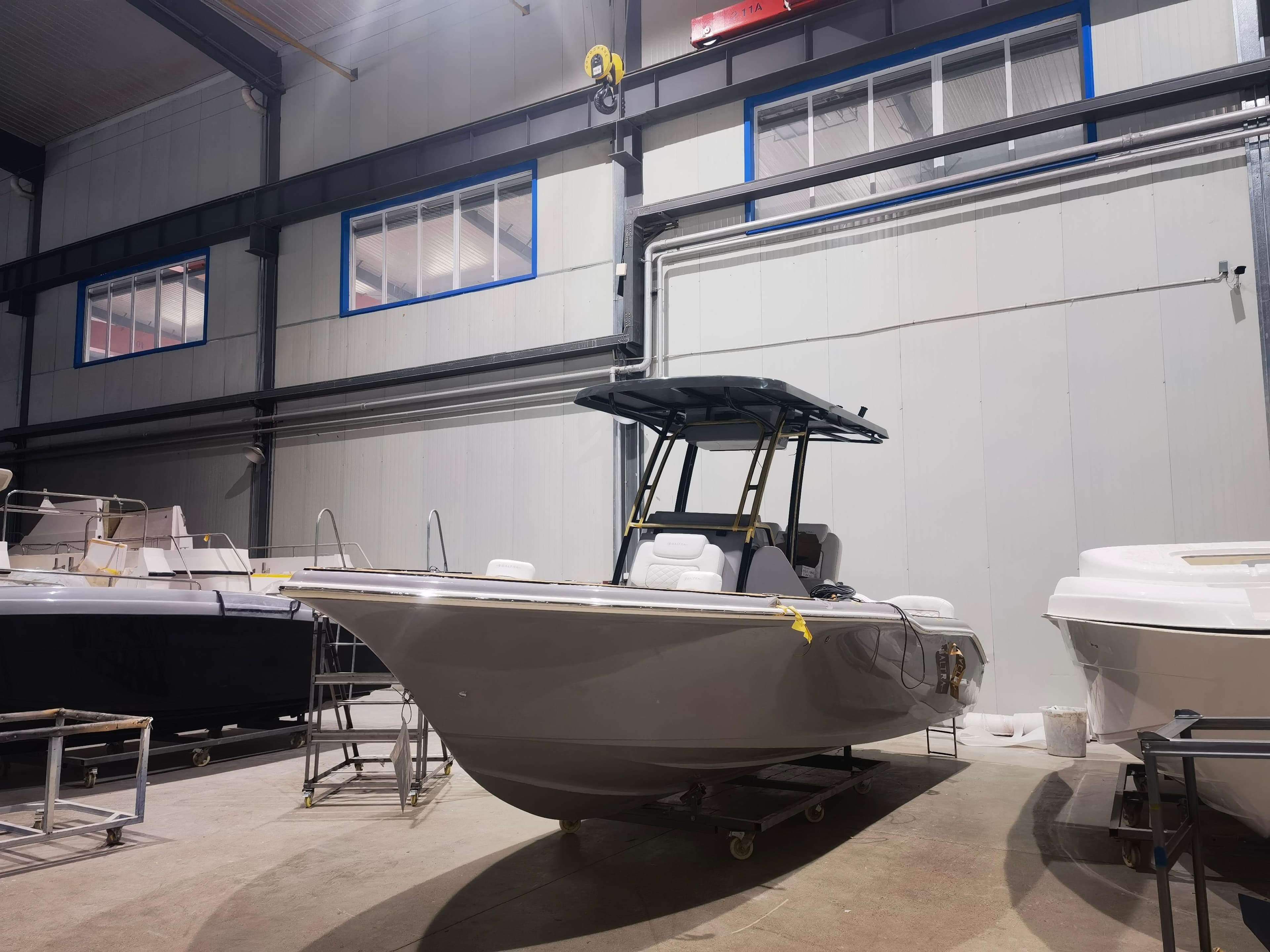 2025 Center Console boat in a warehouse, showcasing sleek design and modern features.