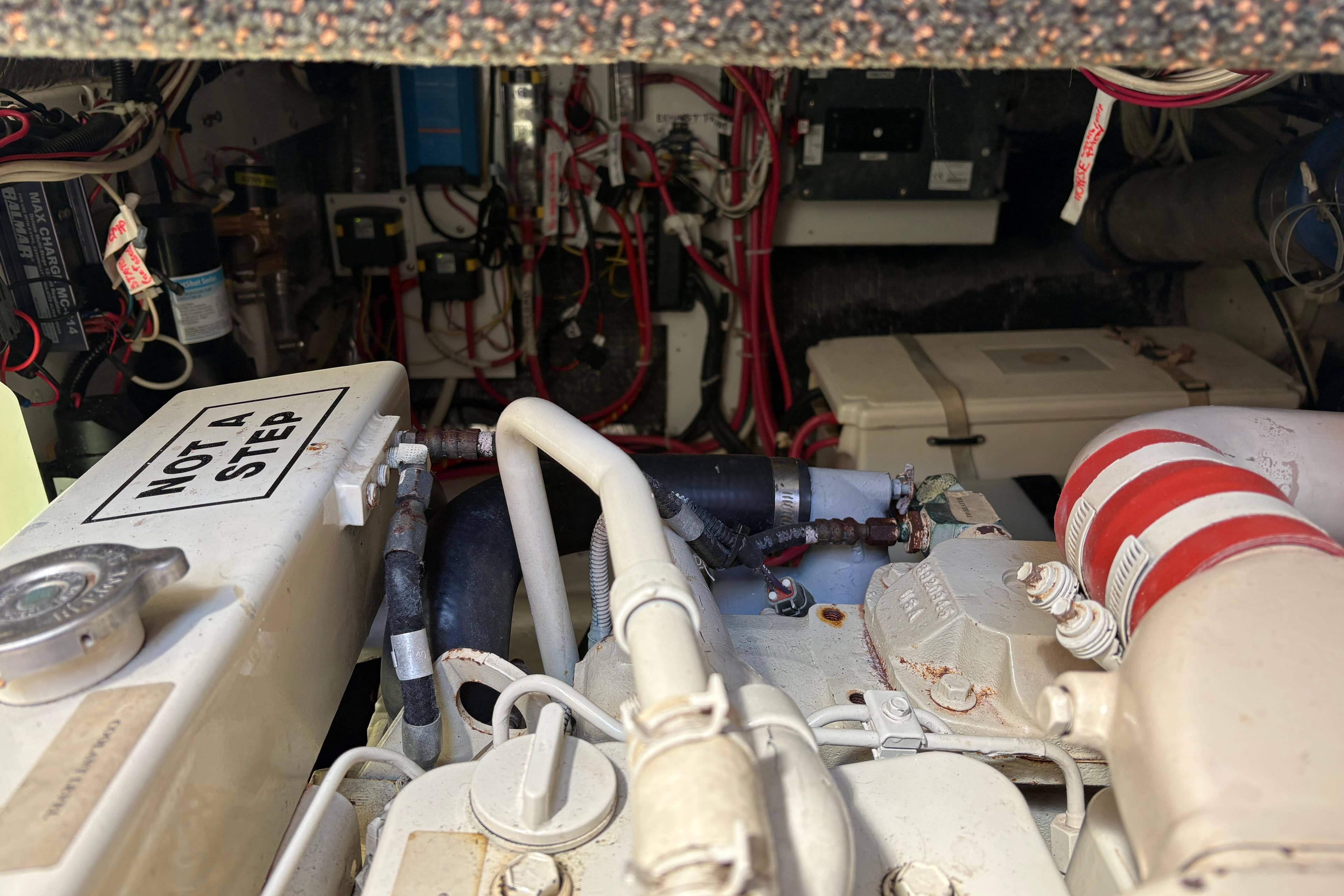 Engine room of a 2004 Nordic Tug 32, featuring complex wiring and components.