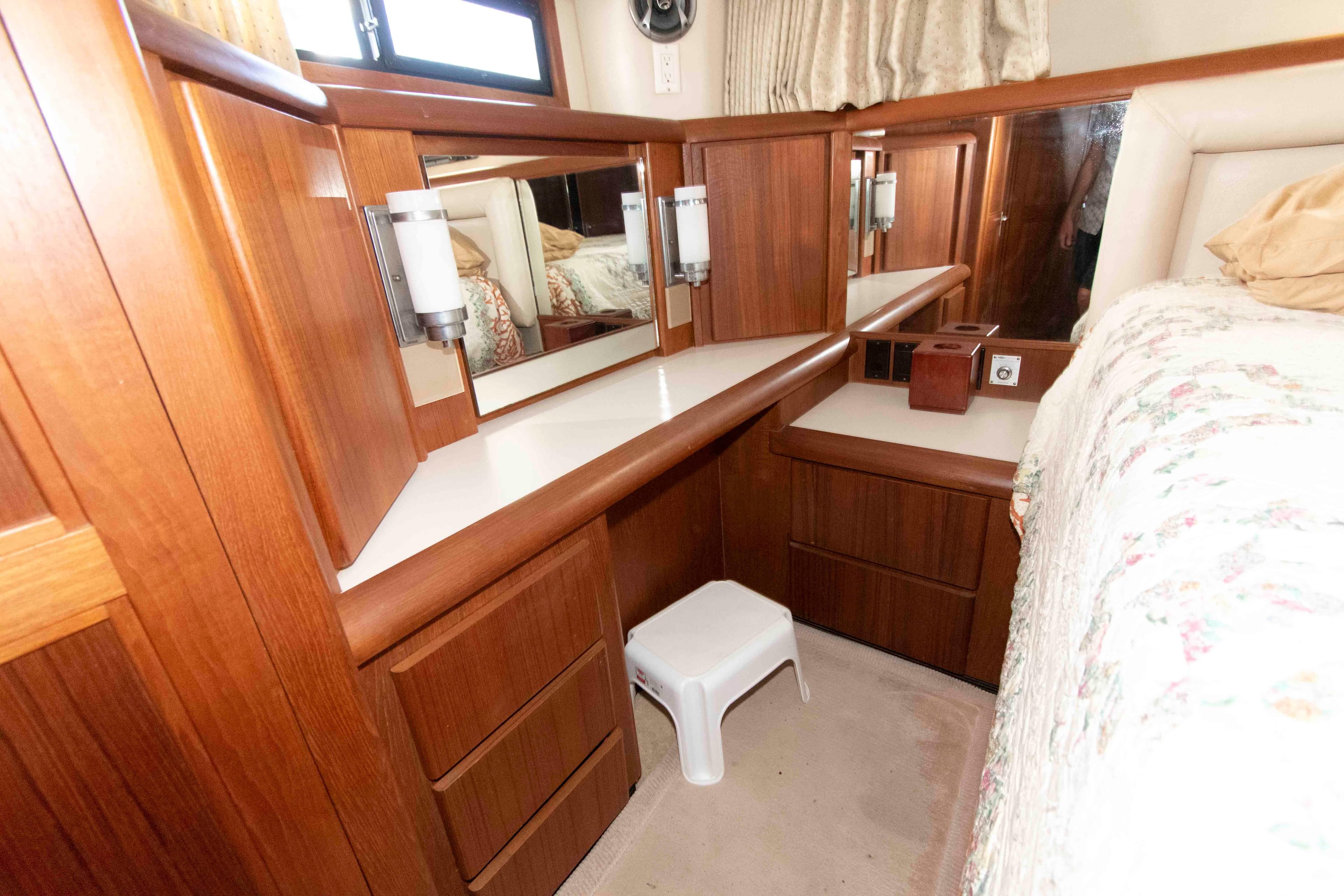 Interior of 1990 Californian 45 Motor Yacht with wooden cabinetry and mirrors.