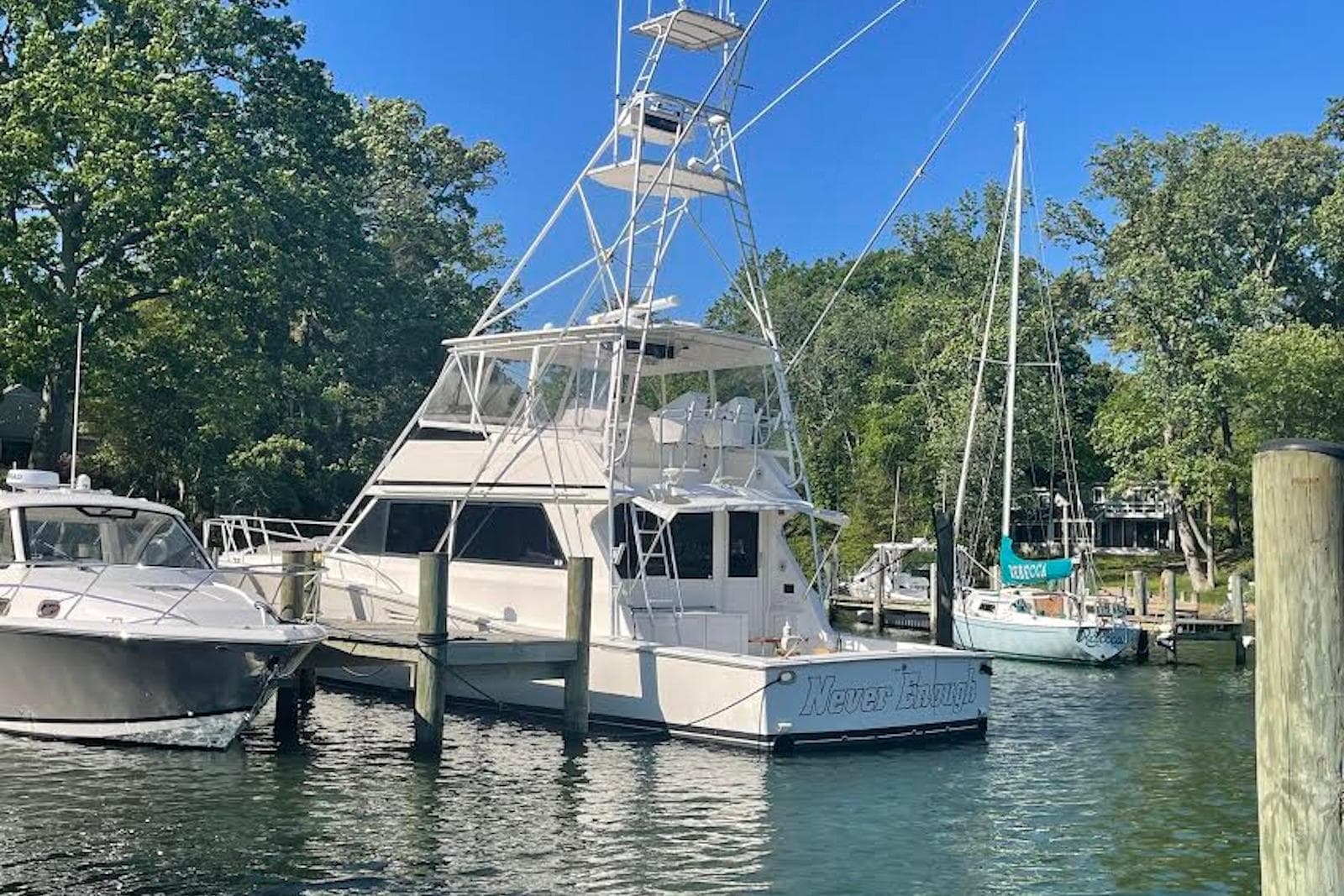 1990 Viking 53 Convertible yacht docked in a serene marina setting.