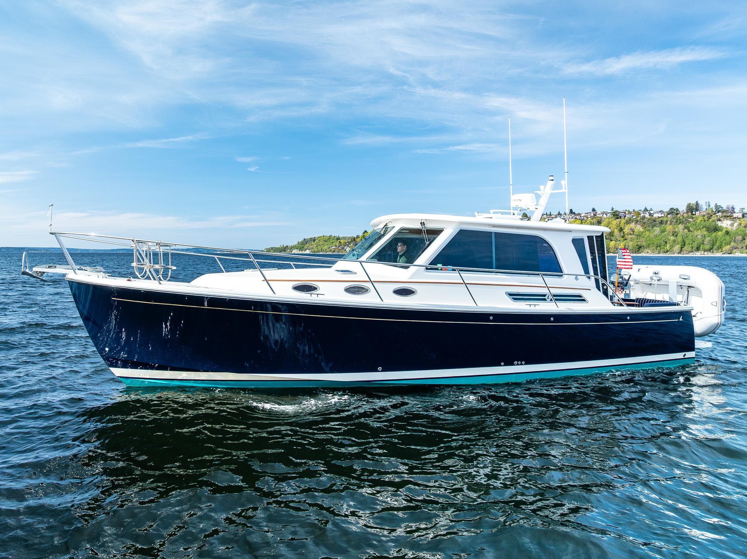 2013 Back Cove 37 boat cruising on open water under a clear blue sky.