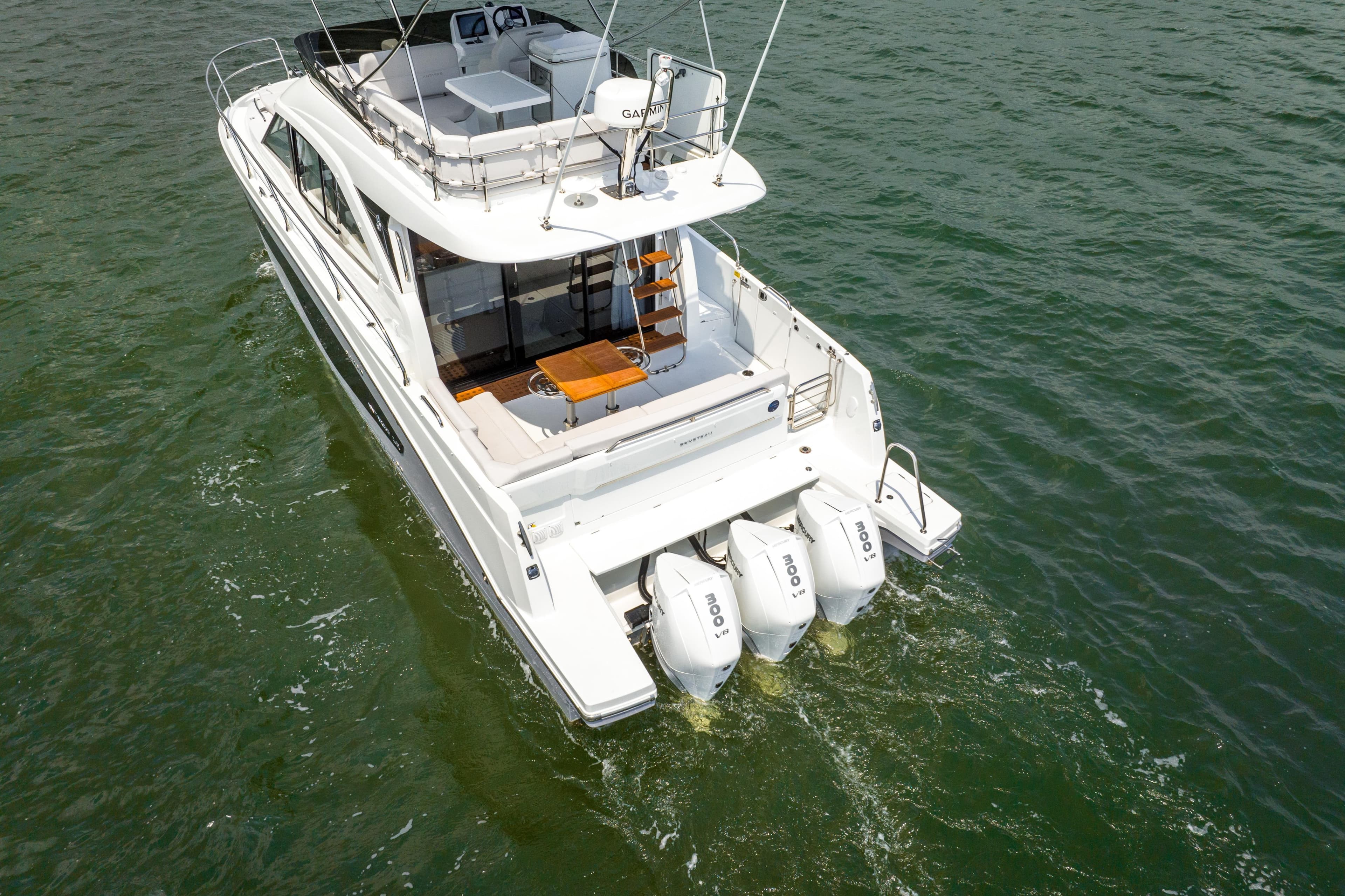 Beneteau Antares 12 Fly 2026 on water with three outboard engines.