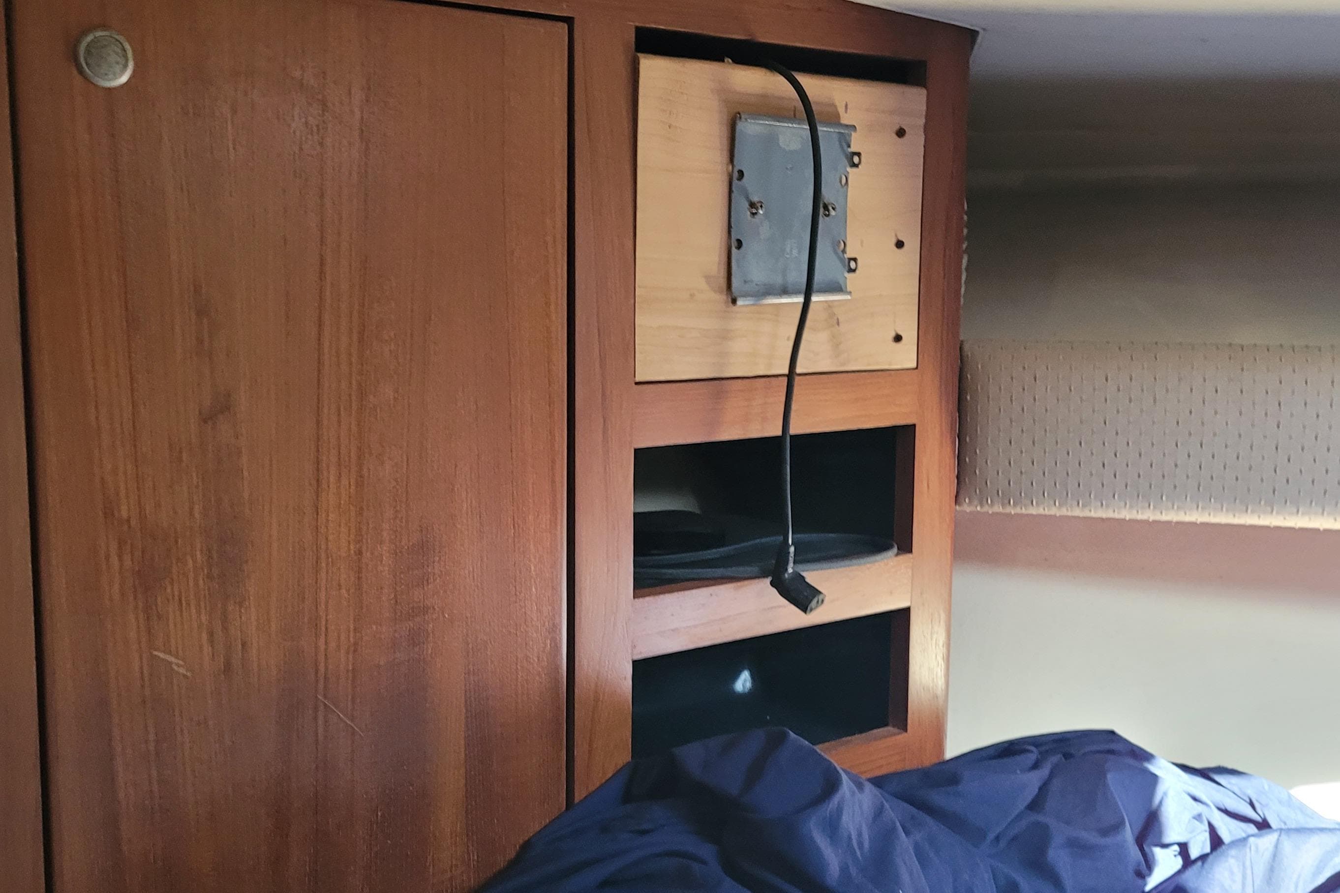 Interior of 2001 Luhrs 34 Convertible boat with wooden cabinetry and storage shelves.