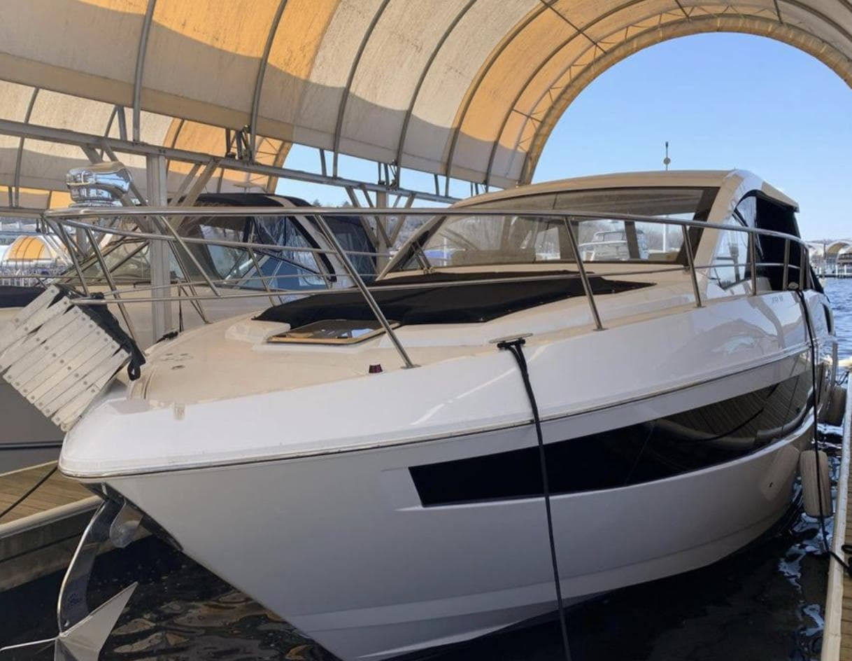 2018 Cruisers 390 Express Coupe docked under canopy.