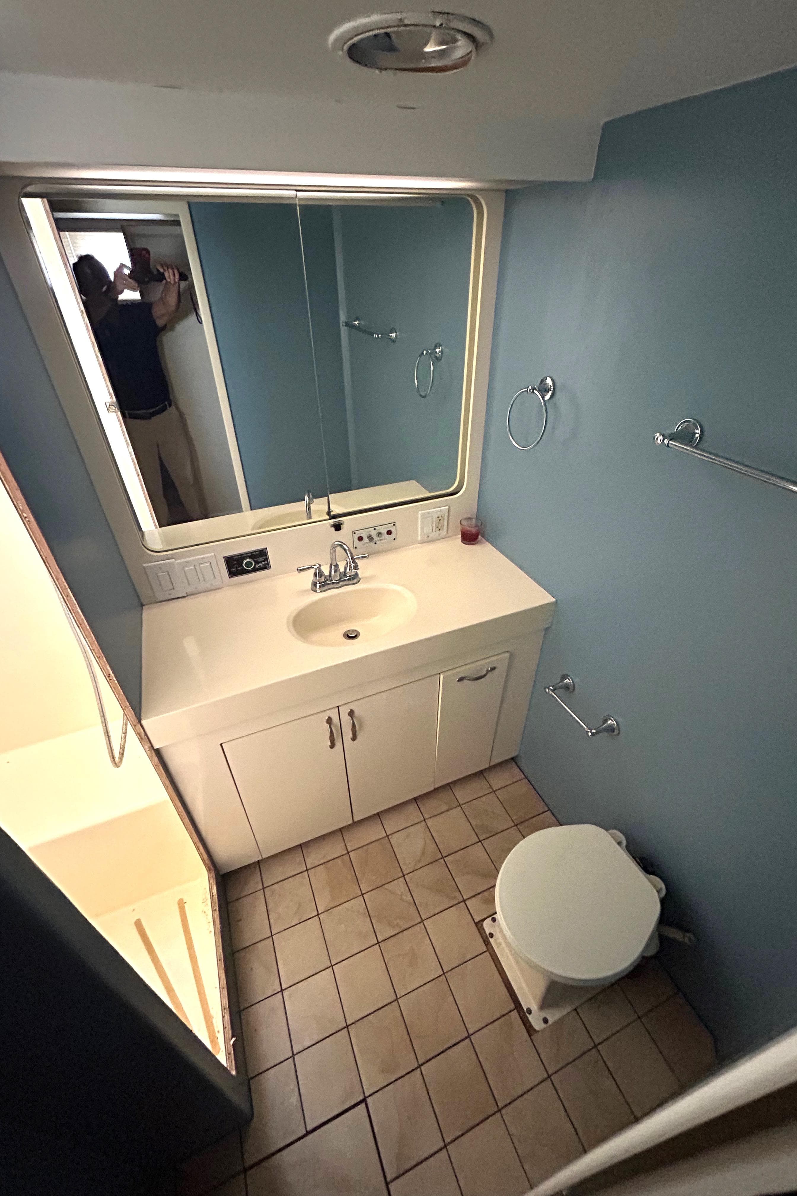 Bathroom interior of 1991 Hatteras Cockpit Motor Yacht with sink and toilet.
