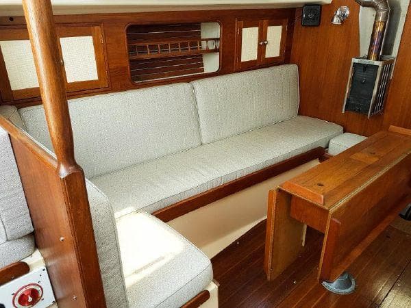 1977 Ontario Yachts 32 interior with wooden finish and cushioned seating.