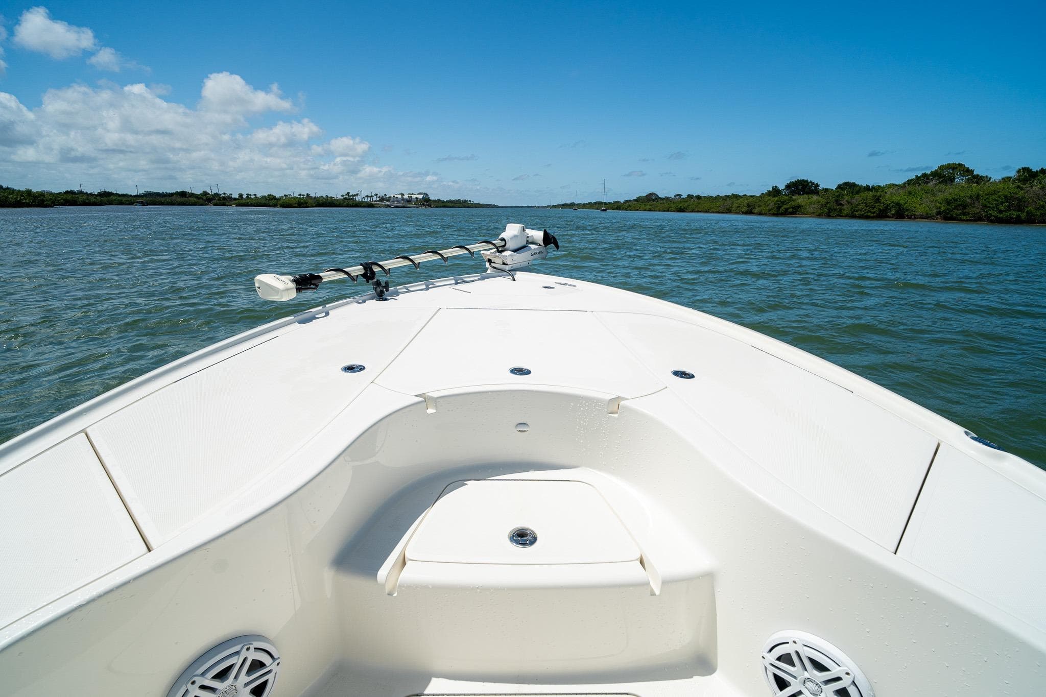 Bow view of 2018 SeaVee 270Z boat on a sunny day, cruising through calm waters.