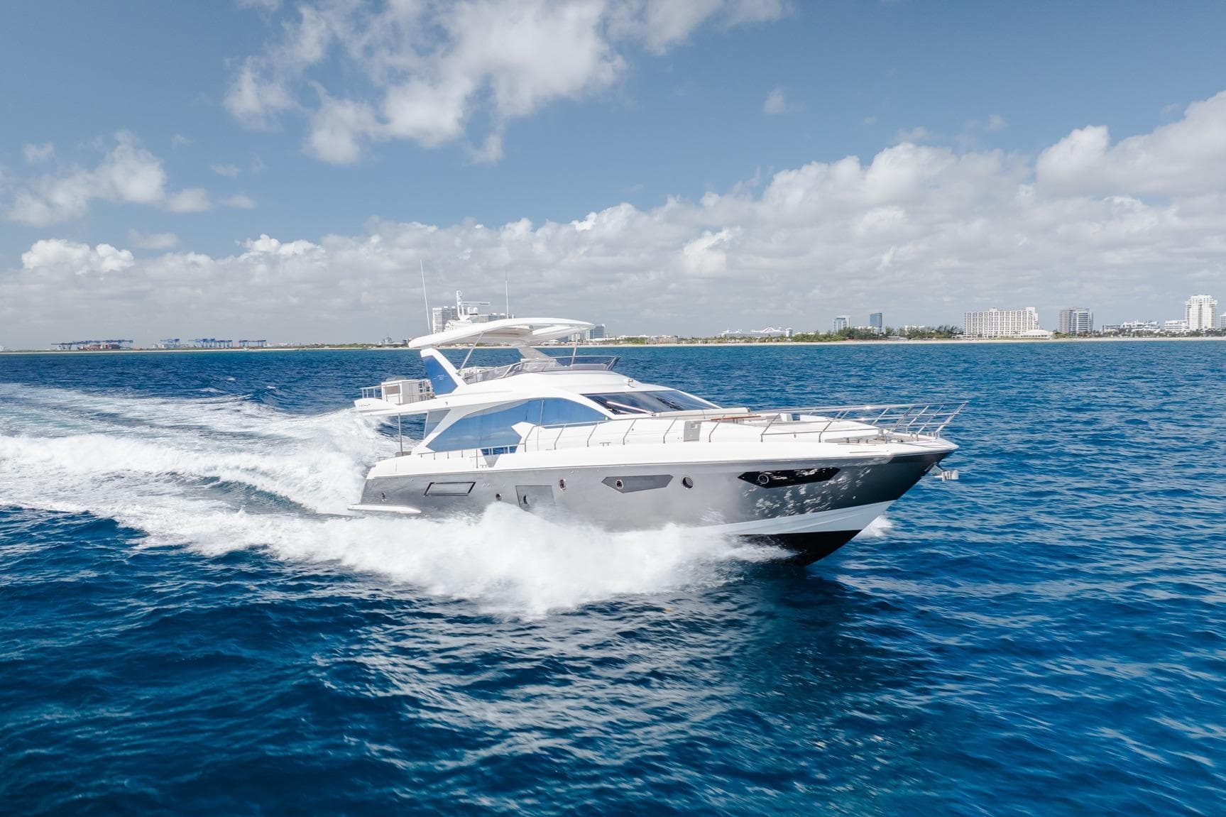 Luxurious 2017 Azimut Fly 72 yacht cruising on open blue waters under a clear sky.