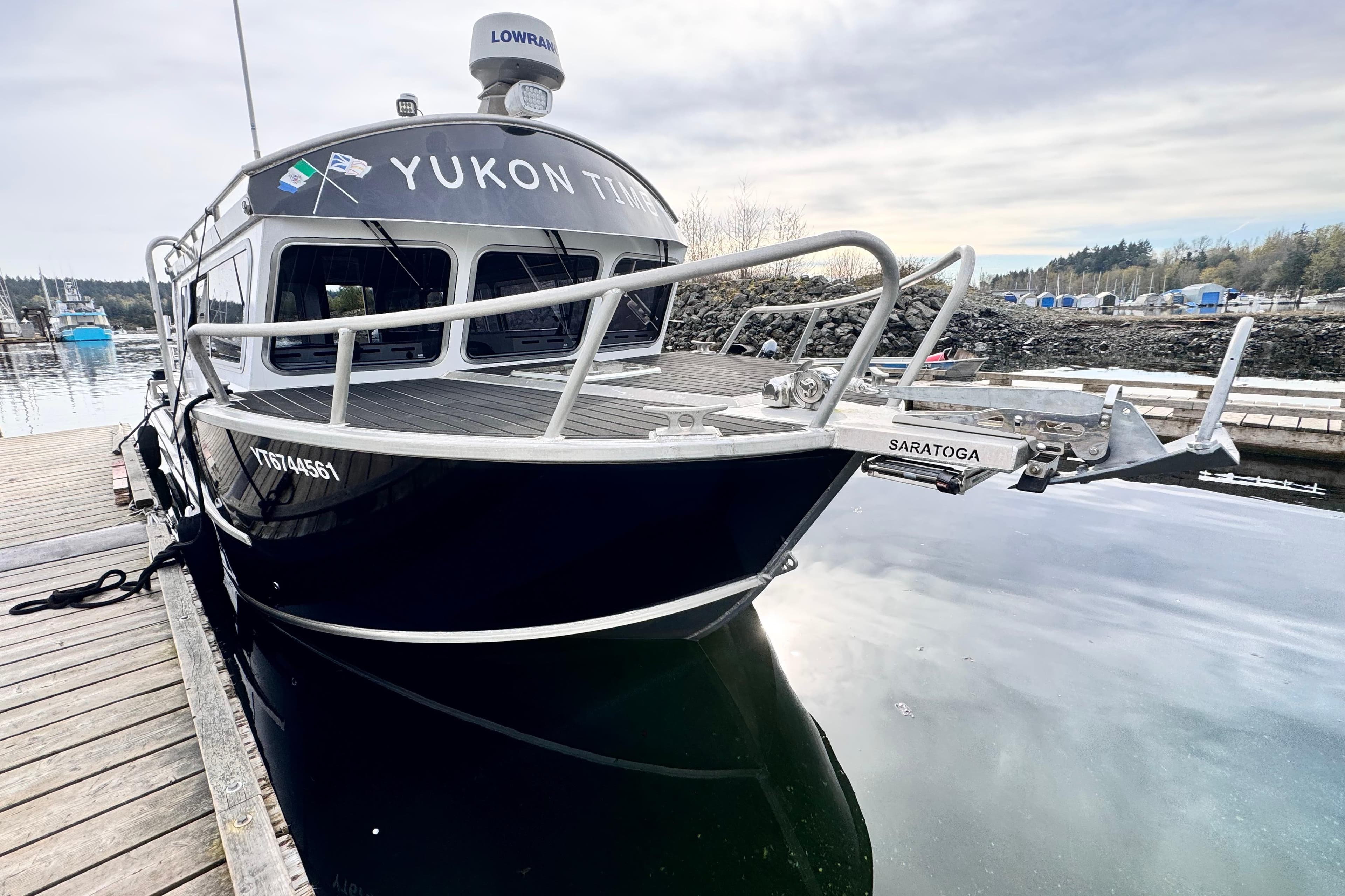 2019 Riptide Marine Saratoga 35 Cruiser docked at a marina, reflecting on calm water.