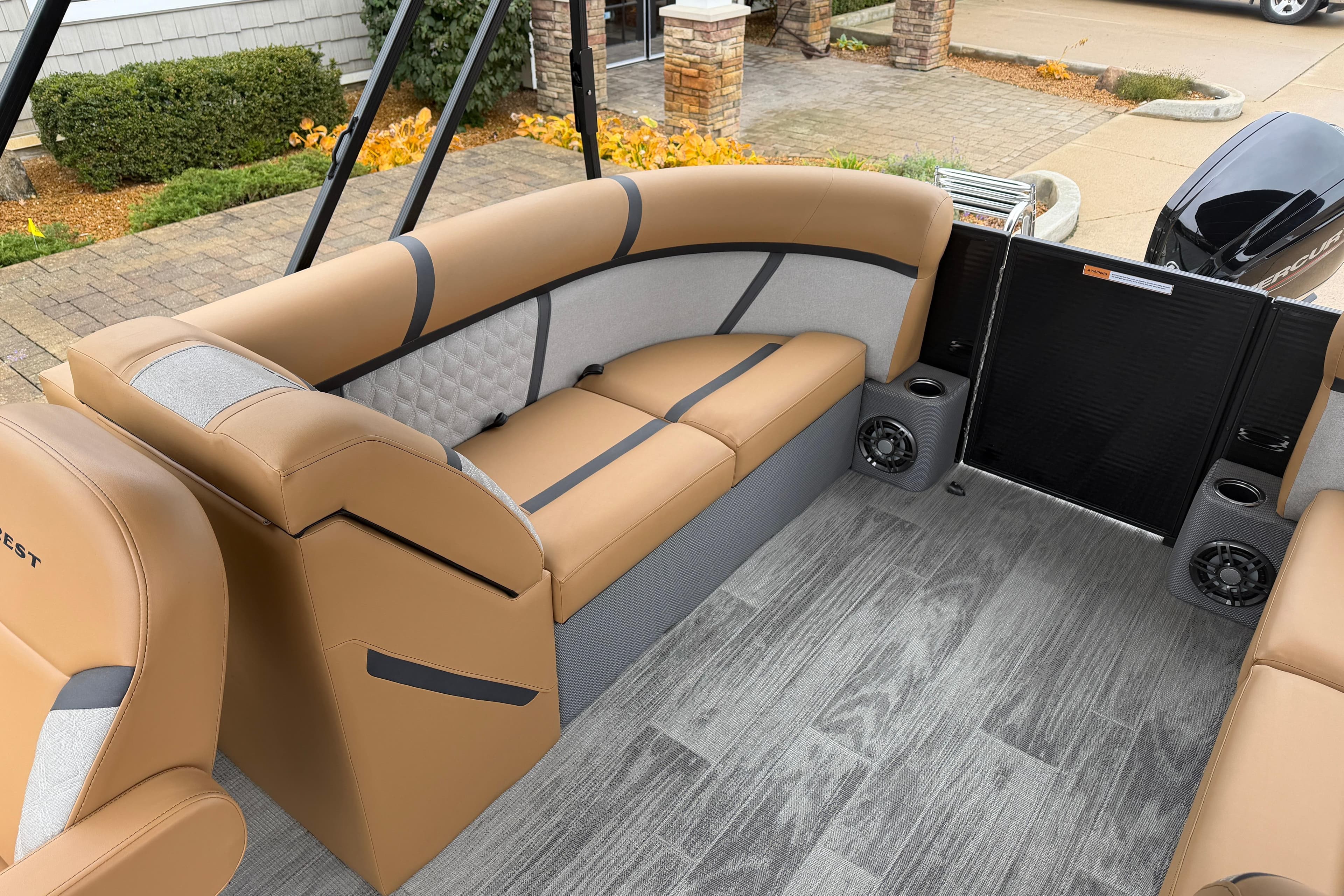 Luxurious interior of 2025 Crest Classic 220 pontoon boat with tan seating and modern flooring.