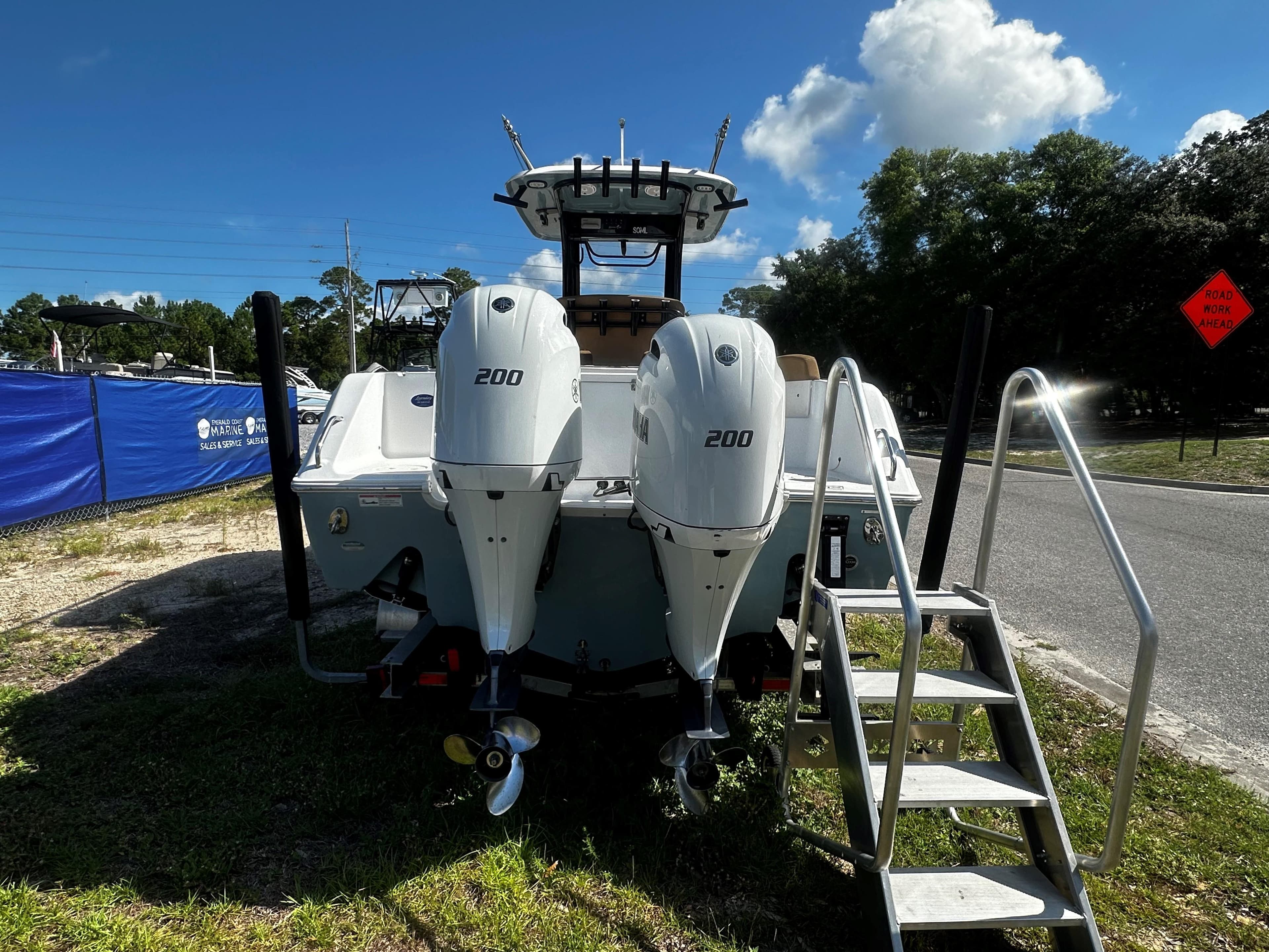 2020 Sea Hunt Gamefish 27 Coffin Box boat with twin Yamaha 200 engines, parked outdoors.