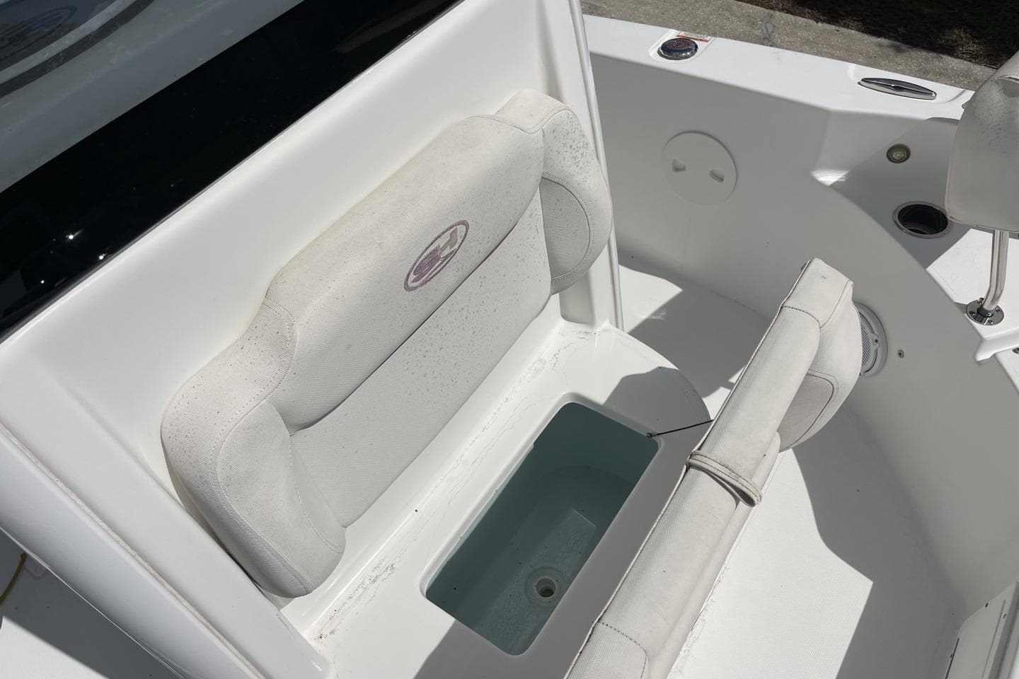 2020 Sea Hunt BX 25 FS boat seating area with storage compartment.