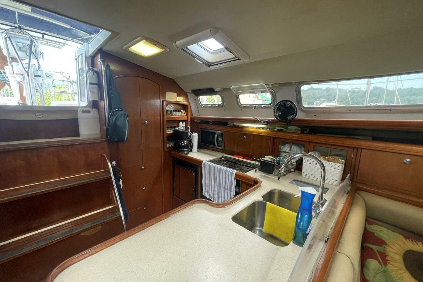 Interior of 2004 Hunter 44 sailboat kitchen with wooden cabinetry and modern appliances.