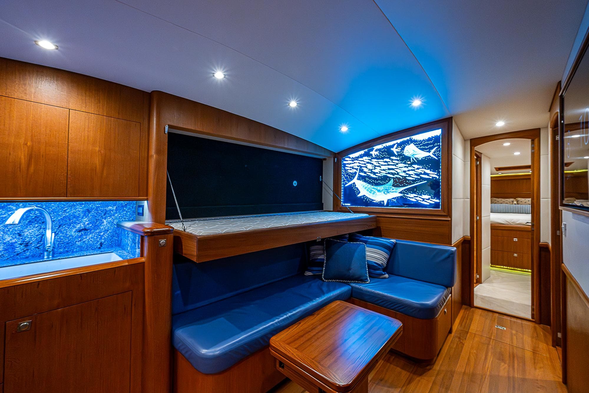 Luxurious 2017 F&S Custom Express Sportfish yacht interior with blue seating and wood accents.
