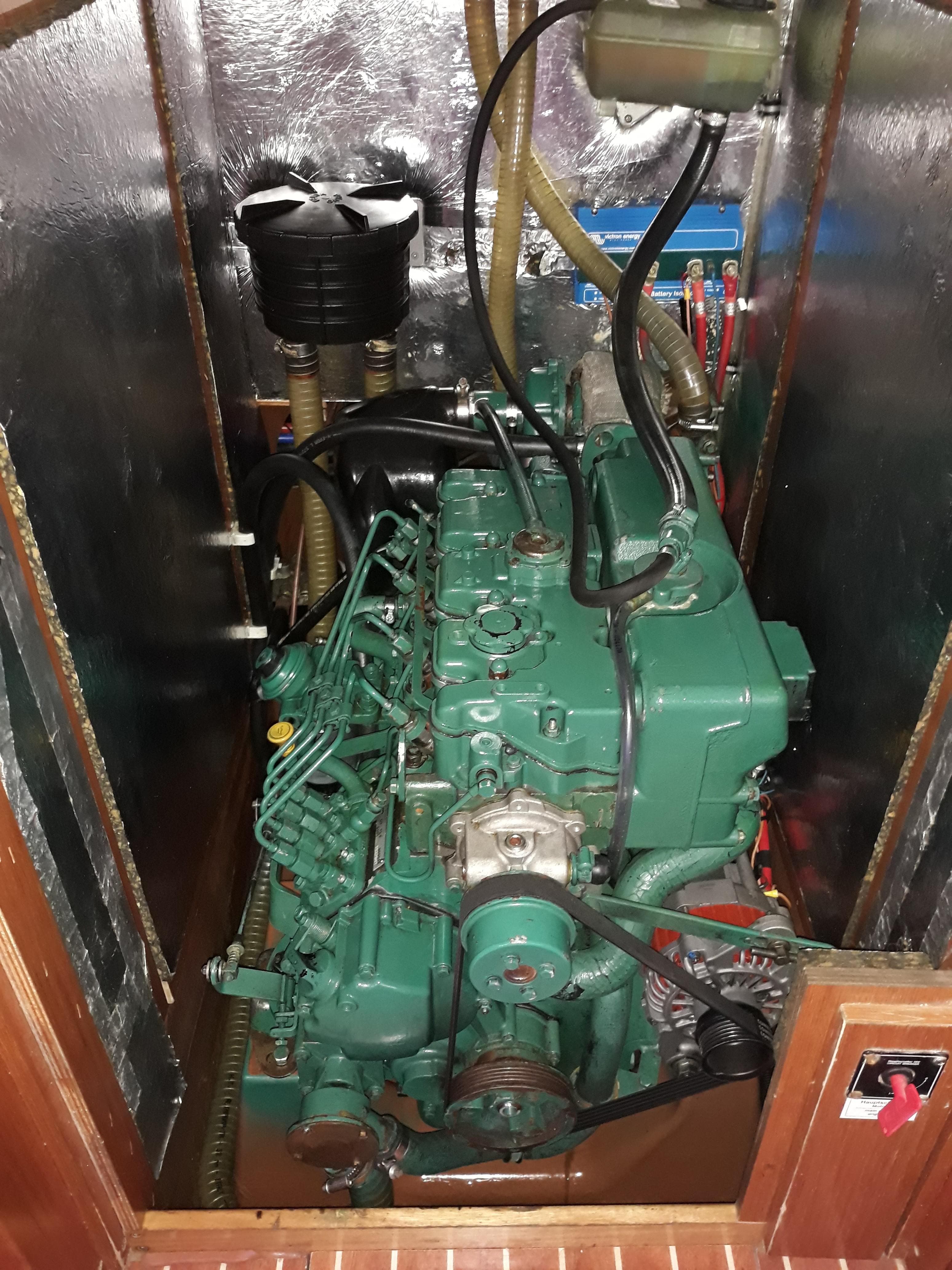Engine compartment of a 2010 Bavaria Cruiser 51 sailboat, showcasing a green marine engine.