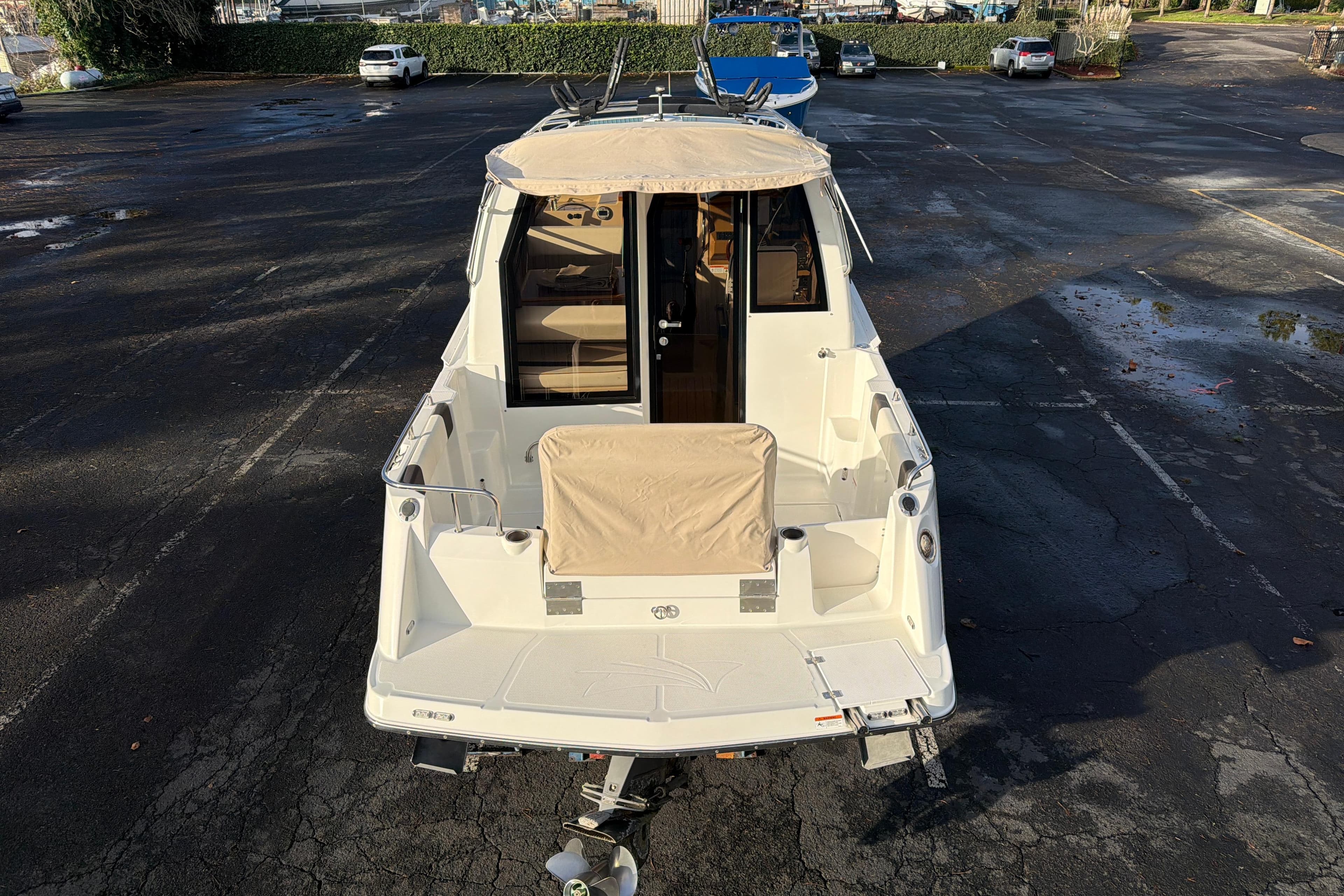 2016 Cutwater C-242 Coupe boat parked in a lot, rear view.
