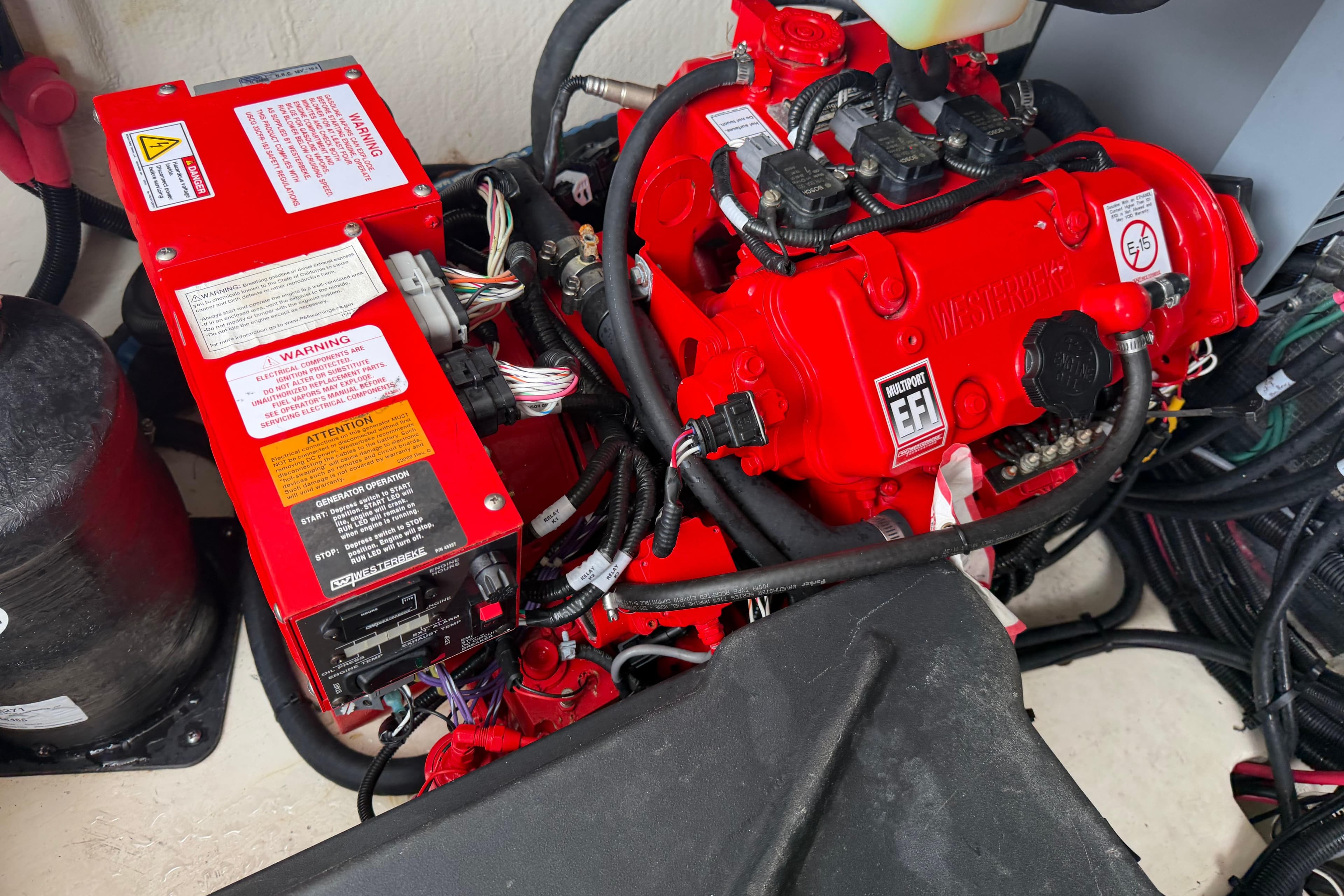Engine compartment of a 2021 Regal 36 XO boat, featuring red components and wiring.