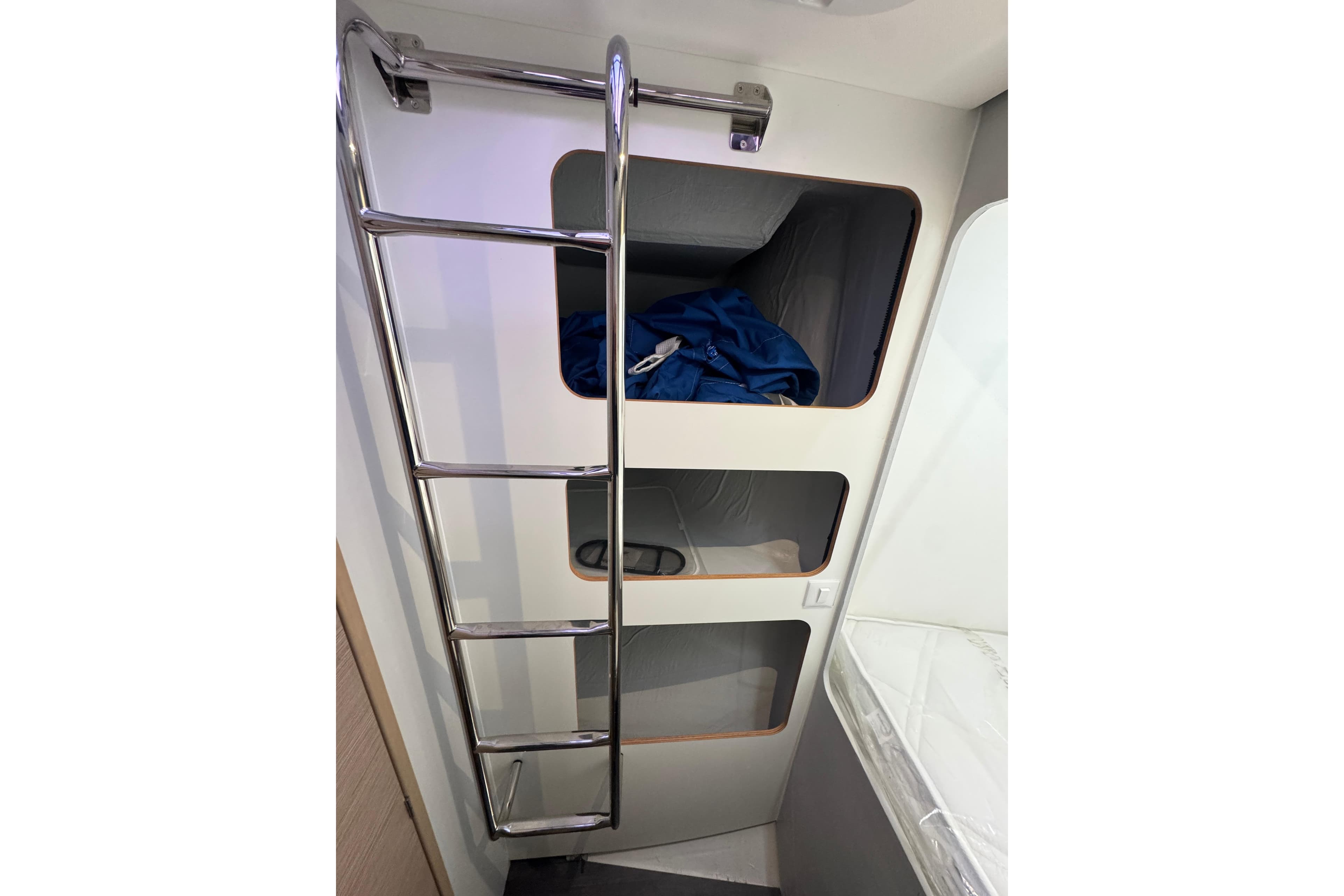 Interior of 2021 Fountaine Pajot Saona 47 catamaran with bunk beds and ladder.