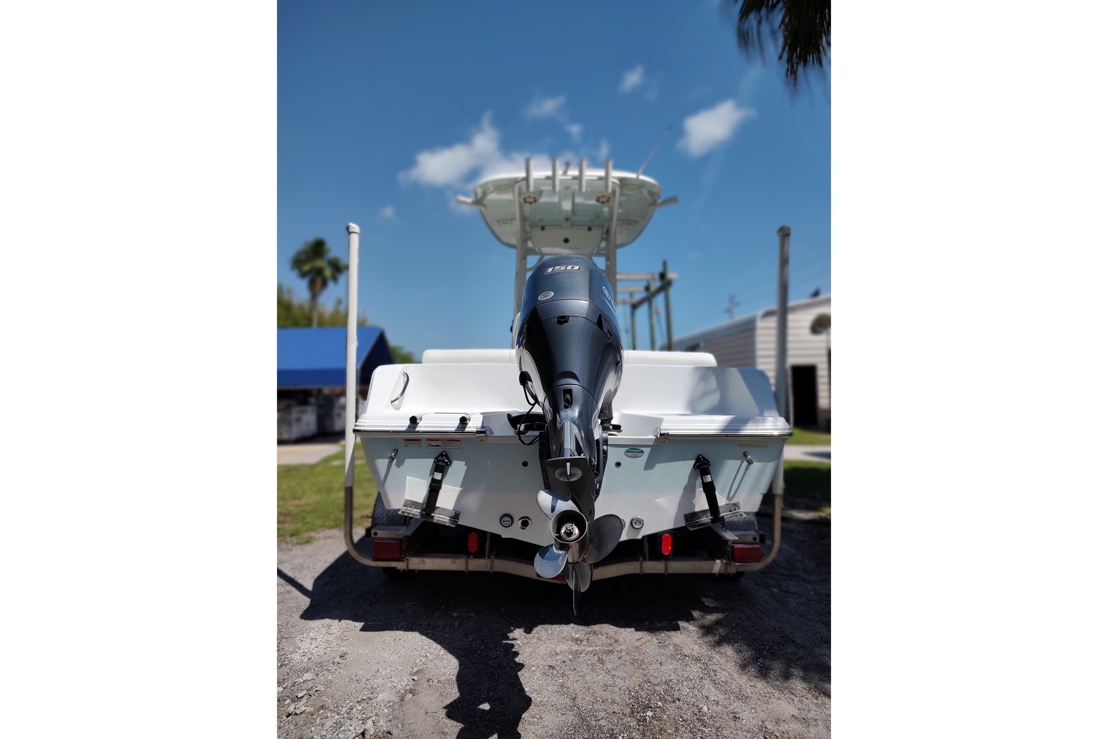 2020 Sportsman Heritage 211 Center Console boat with outboard motor, parked outdoors.