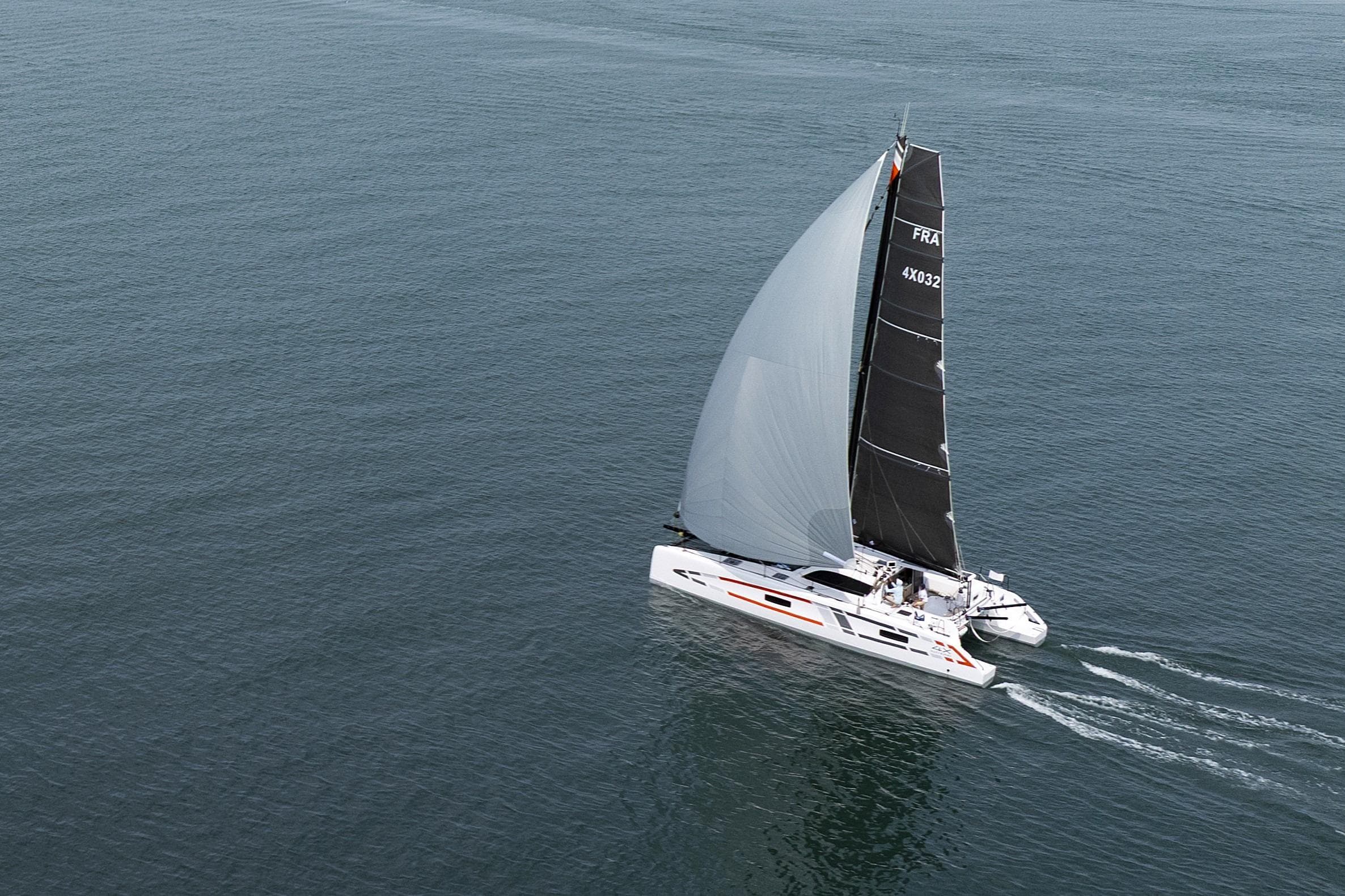2025 Outremer 4X catamaran sailing on open water, showcasing sleek design and performance.