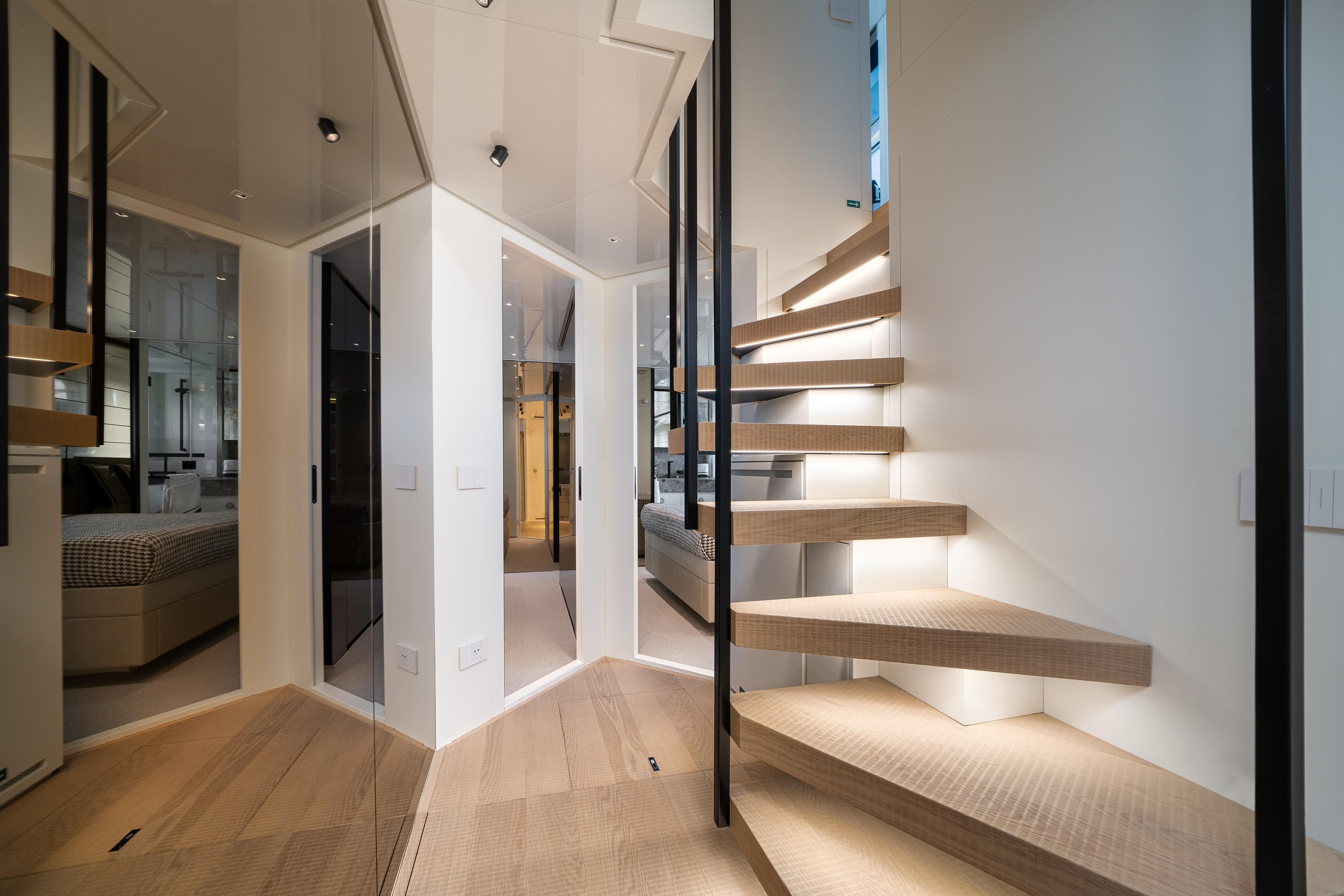 Modern interior of 2022 Sanlorenzo SL96A yacht with sleek staircase and elegant design.