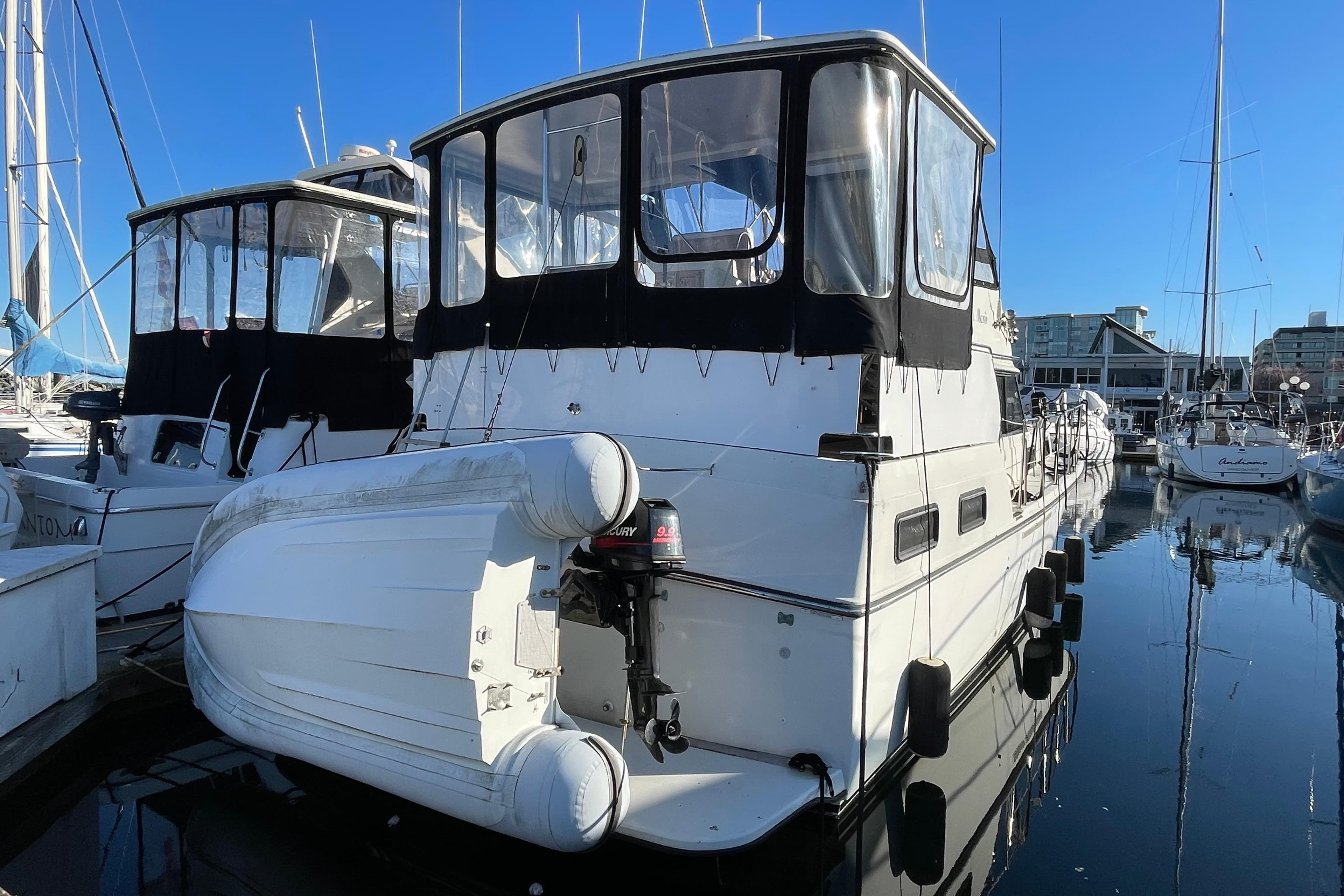 1988 Carver 3607 Aft Cabin Motor Yacht docked at marina, clear blue sky.