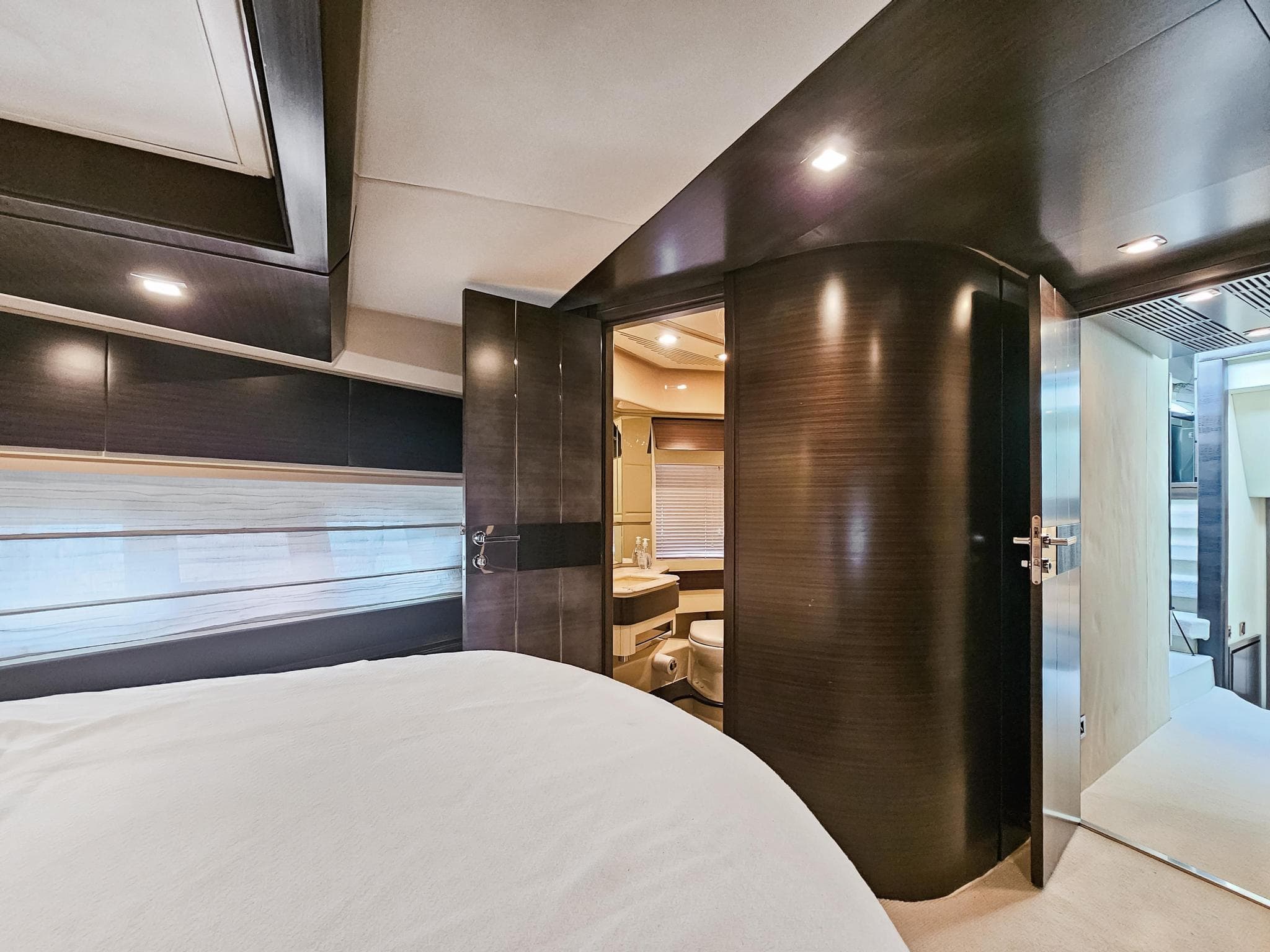 Luxurious interior of 2013 Azimut 70 yacht, featuring modern bedroom and bathroom.