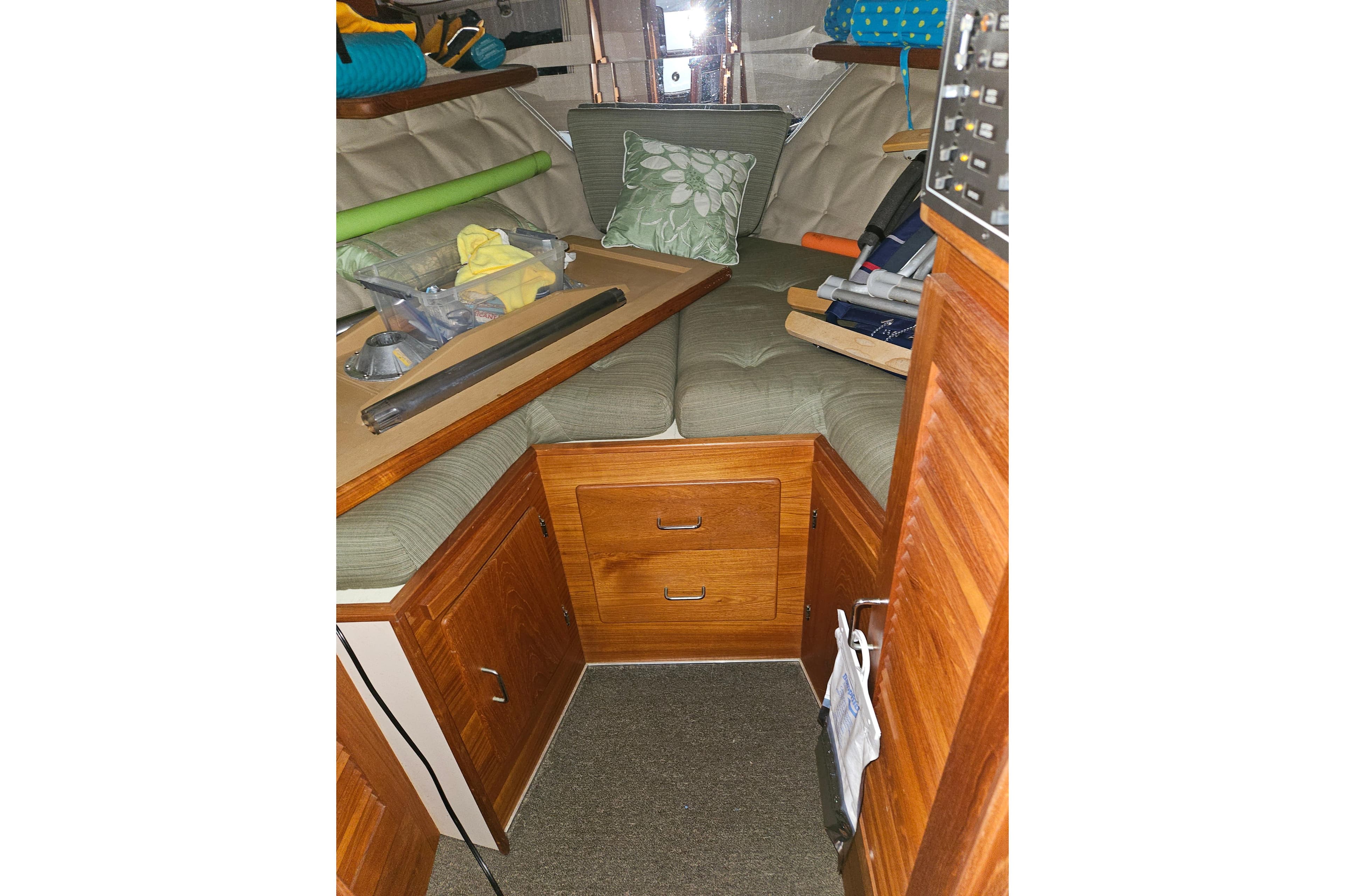 1989 Tollycraft Sport Sedan interior with wooden cabinetry and cushioned seating.