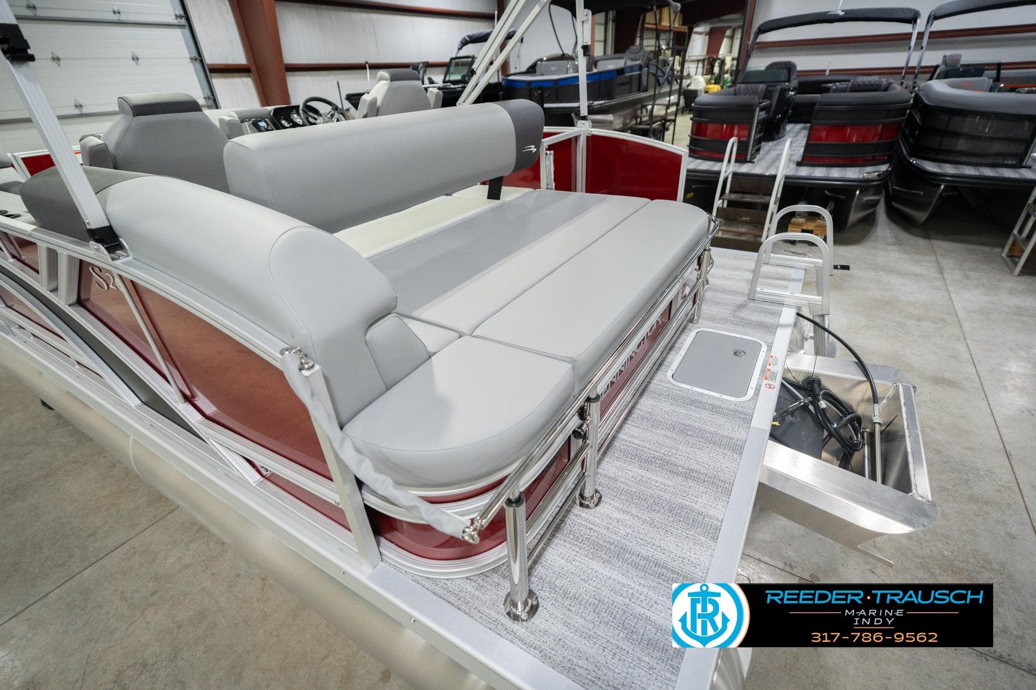 2026 Bennington 20 SSR pontoon boat with gray seating in showroom.