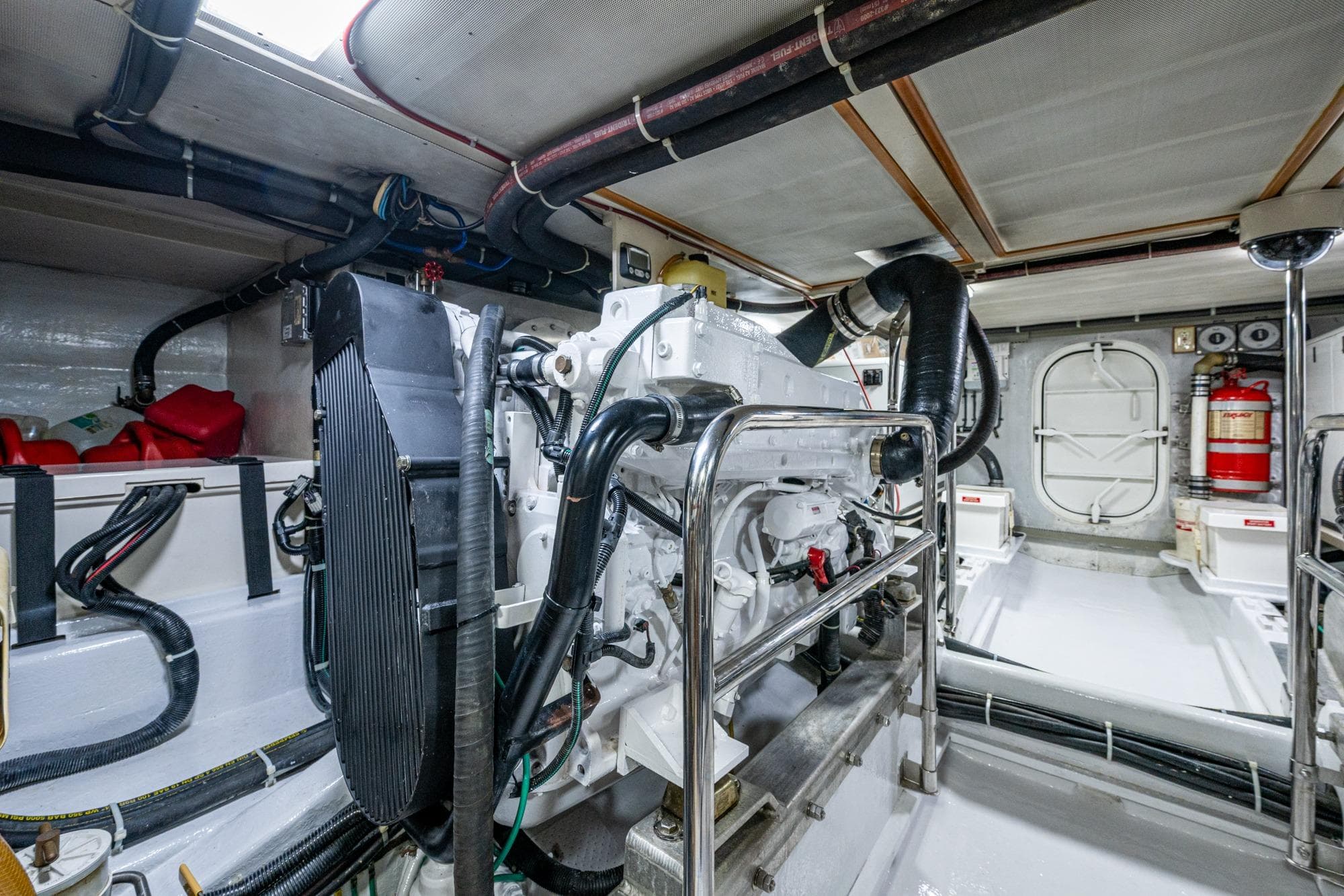 Engine room of a 2006 Krogen 58 yacht, featuring machinery and safety equipment.