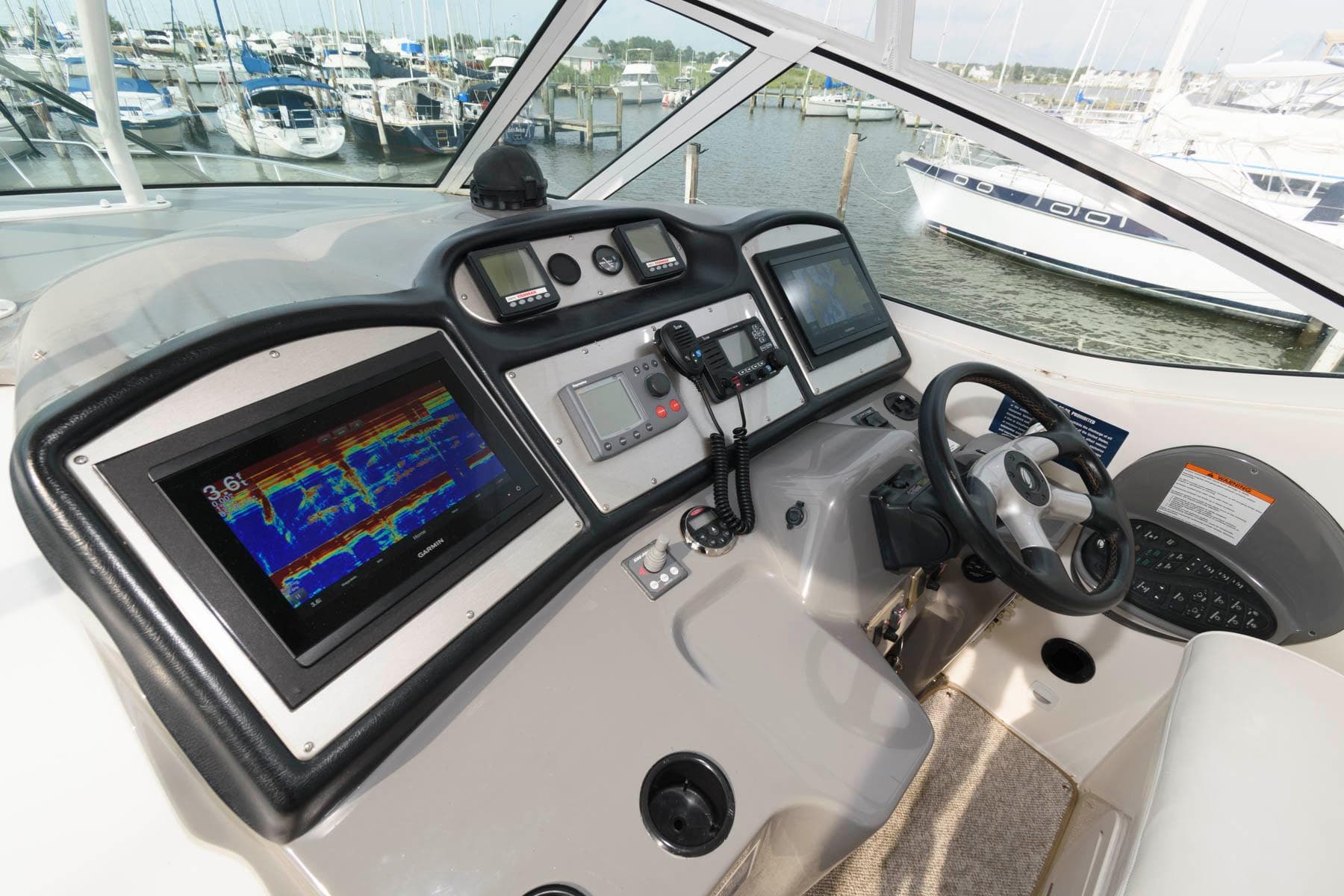 2007 Cruisers Yachts 415 Express Motoryacht helm station in marina.