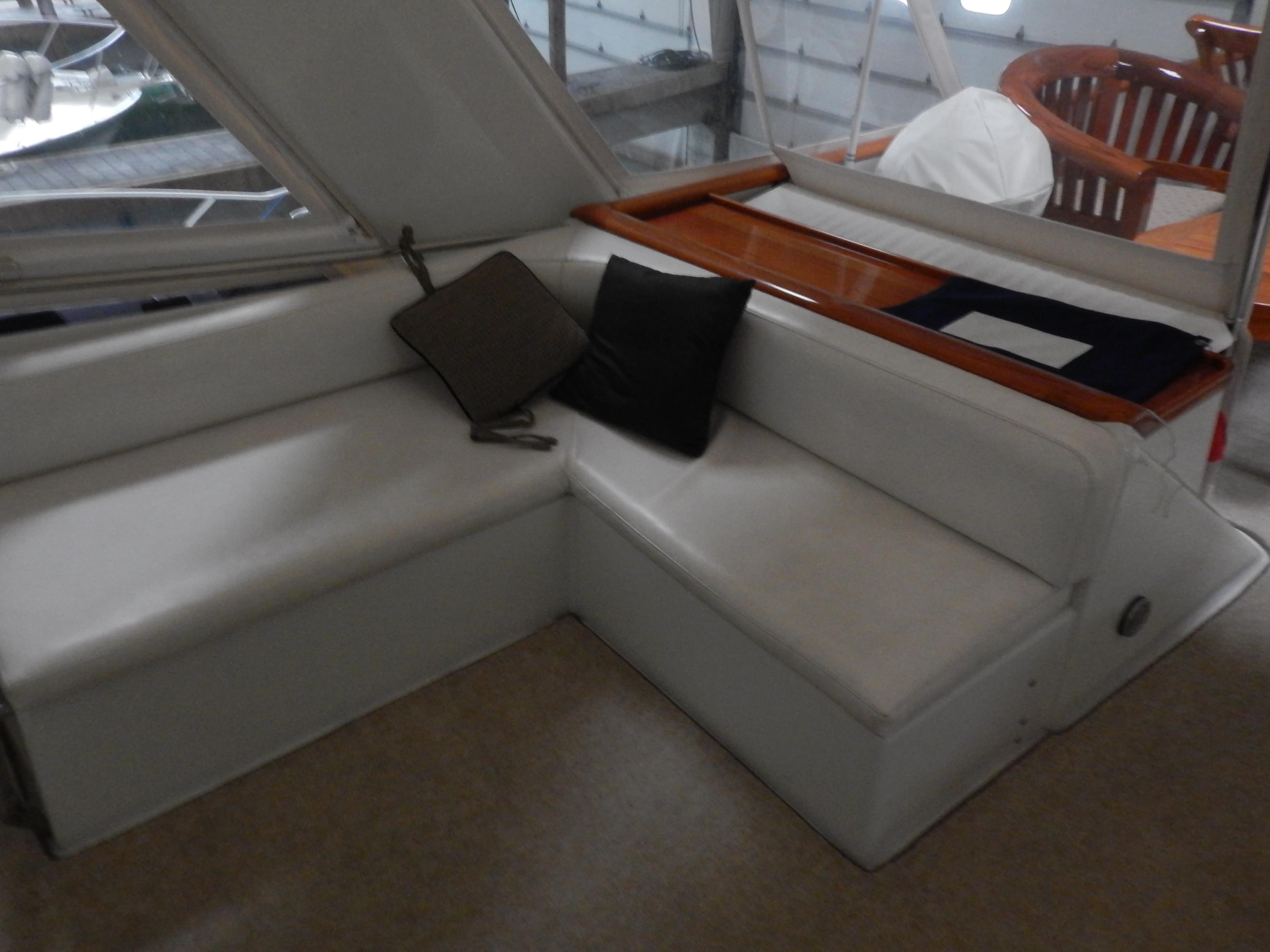1974 Pacemaker Cockpit Motoryacht interior with white seating and cushions.