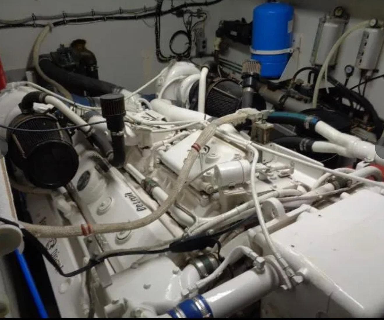 Engine room of 1989 Hatteras 67 Cockpit Motor Yacht with visible machinery and components.