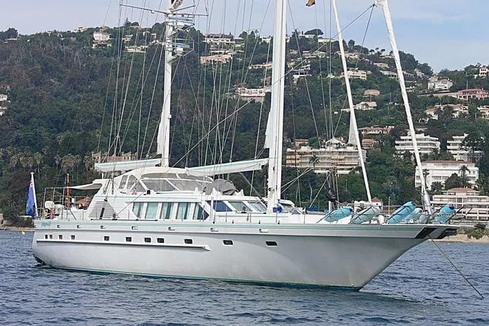 Elegant 1990 One Off Brandstätter 31m Motor Sailor yacht on serene coastal waters.