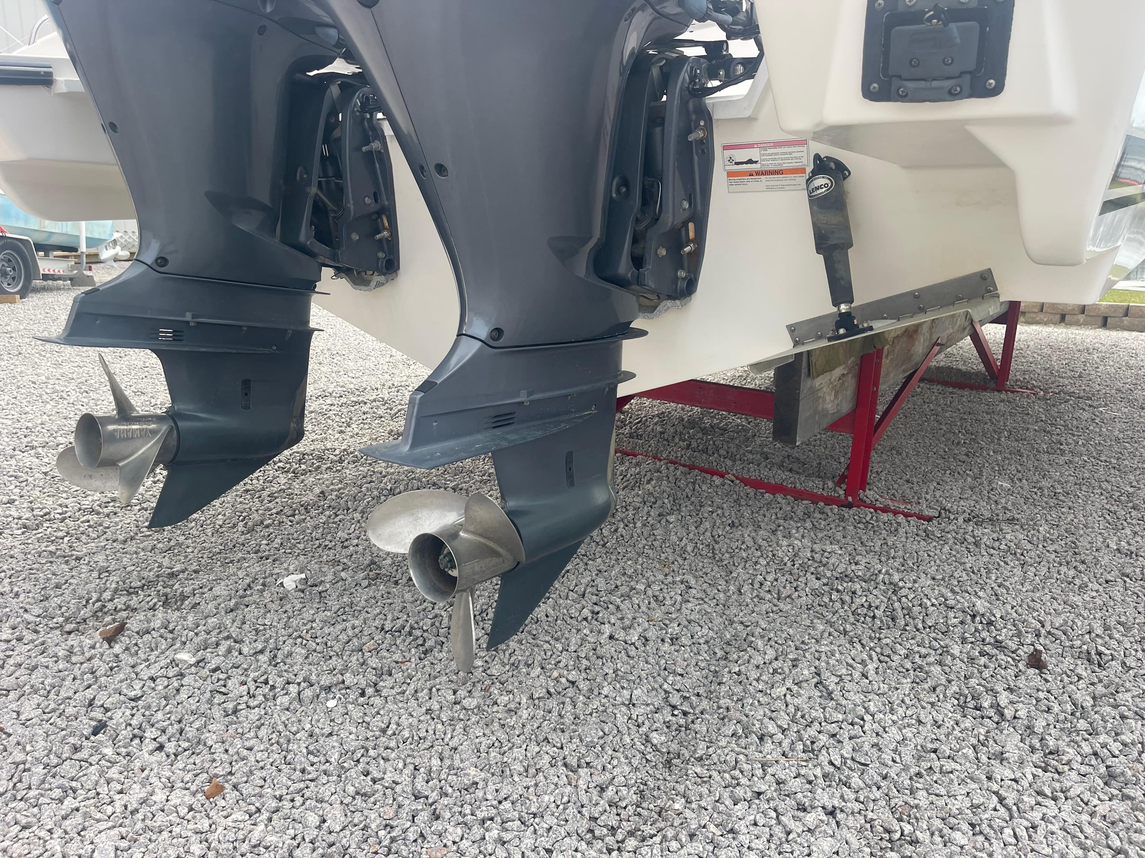 2016 Pursuit DC 325 Dual Console boat engines on gravel.