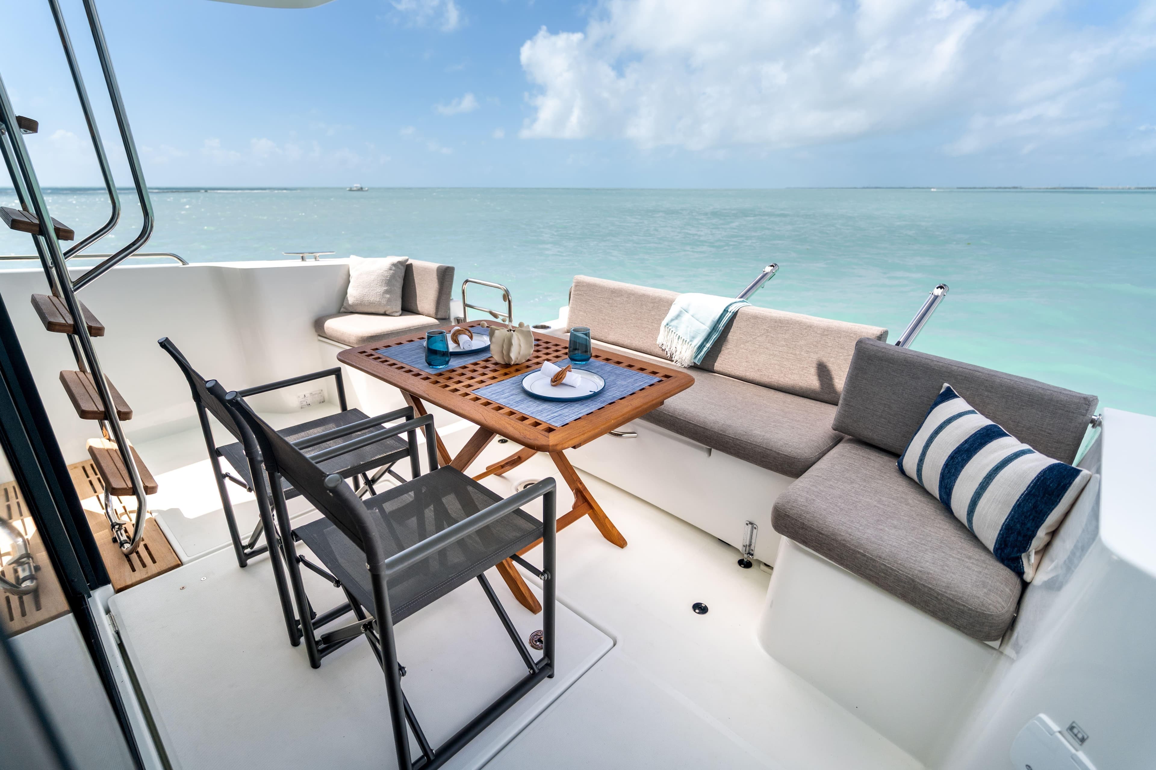 2026 Beneteau Swift Trawler 37 Fly deck with seating, table, and ocean view.