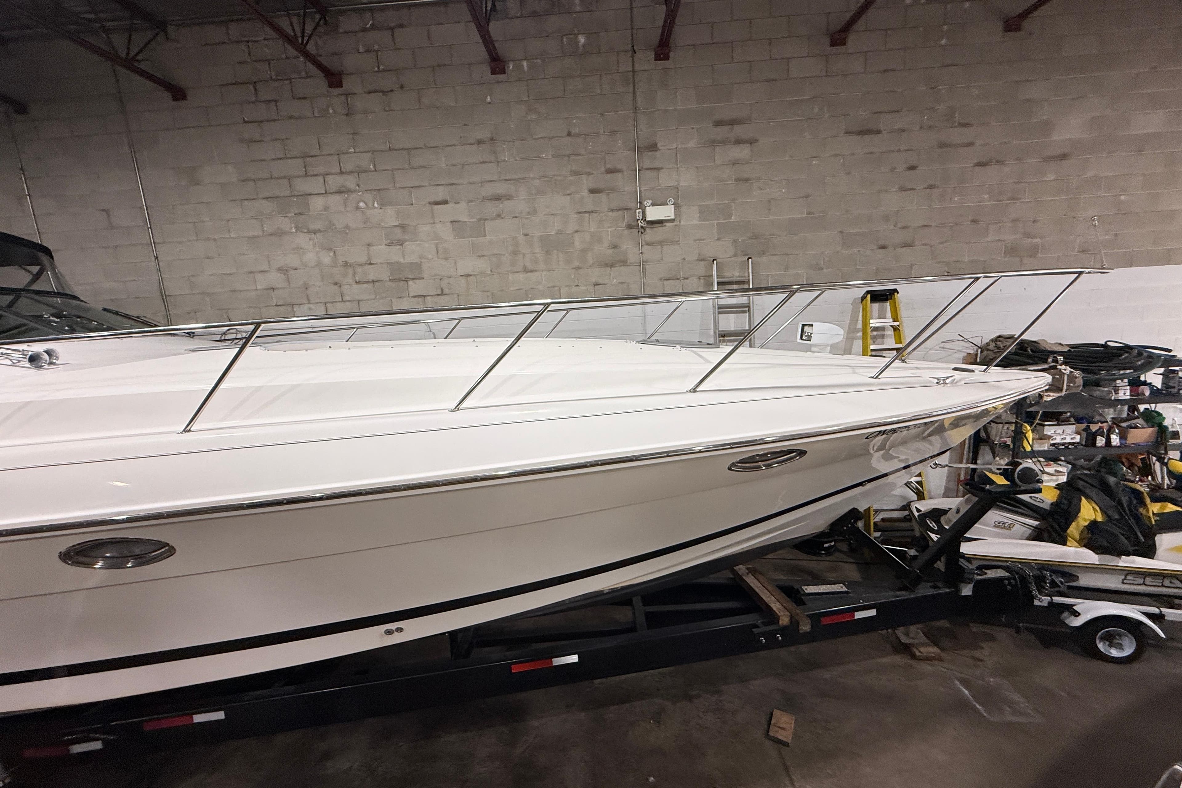 1999 Wellcraft 45 Excalibur boat in storage, side view, on trailer indoors.