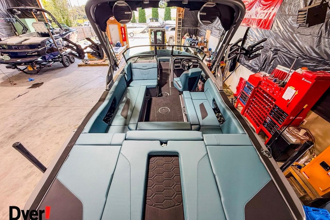 2026 MasterCraft NXT23 boat interior in a workshop, featuring sleek seating and modern design.